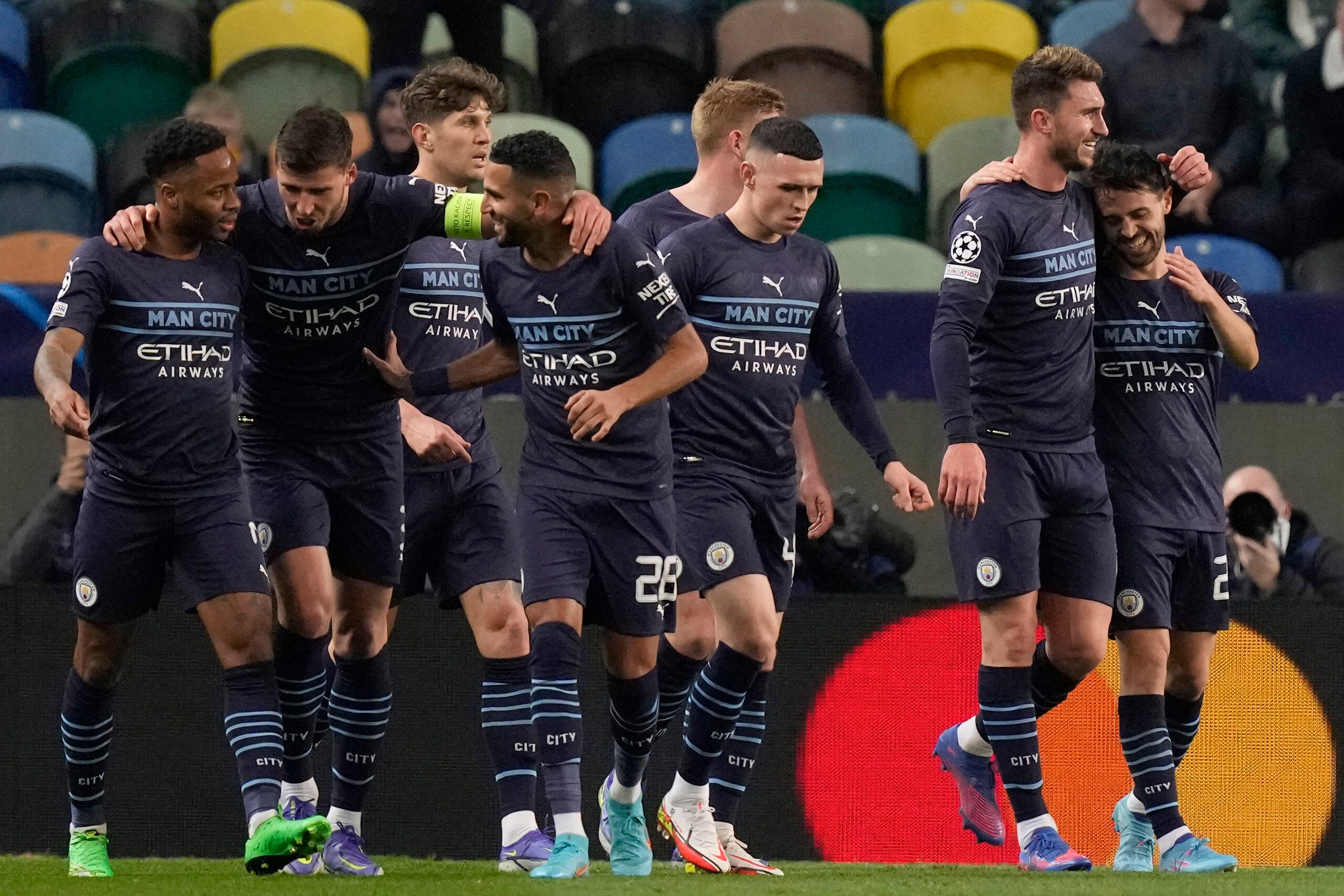 Manchester City players celebrate the second goal of their team during the Champions League round of 16 soccer match between Sporting CP and Manchester City at the Alvalade stadium in Lisbon, Portugal, Tuesday, Feb. 15, 2022. (AP Photo/Armando Franca) Manchester City players celebrate the second goal of their team during the Champions League round of 16 soccer match between Sporting CP and Manchester City at the Alvalade stadium in Lisbon, Portugal, Tuesday, Feb. 15, 2022. (AP Photo/Armando Franca)