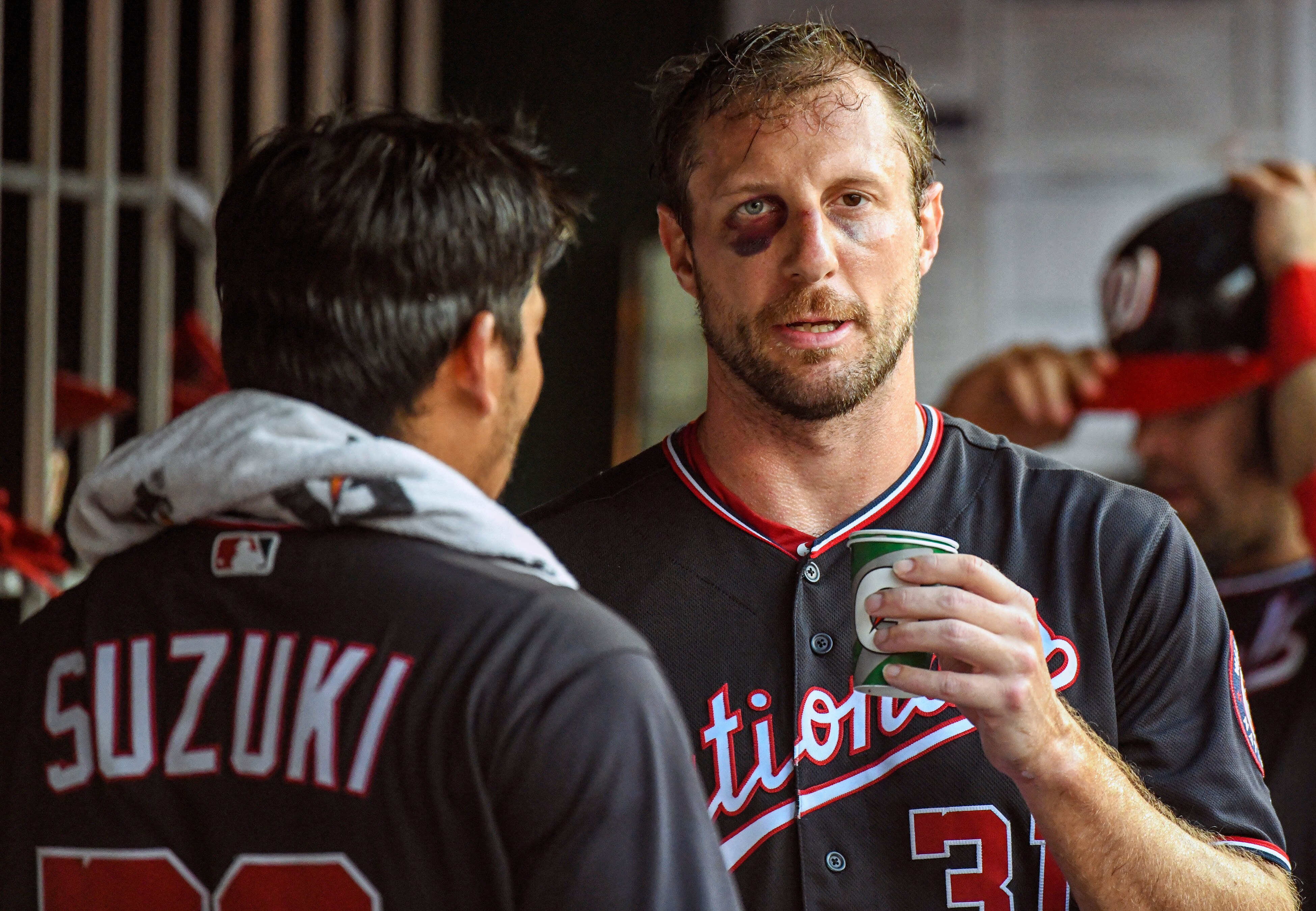 WASHINGTON, DC - JUNE 19:  Washington Nationals starting pitcher Max Scherzer (31) talks with catcher Kurt Suzuki (28) in the dugout after pitching the third inning during the game between the Philadelphia Phillies and the Washington Nationals on June 19, 2019, at Nationals Park, in Washington D.C.  Scherzer broke his nose and got a black eye on Monday after fouling off a bunt during batting practice.  (Photo by Mark Goldman/Icon Sportswire via Getty Images)