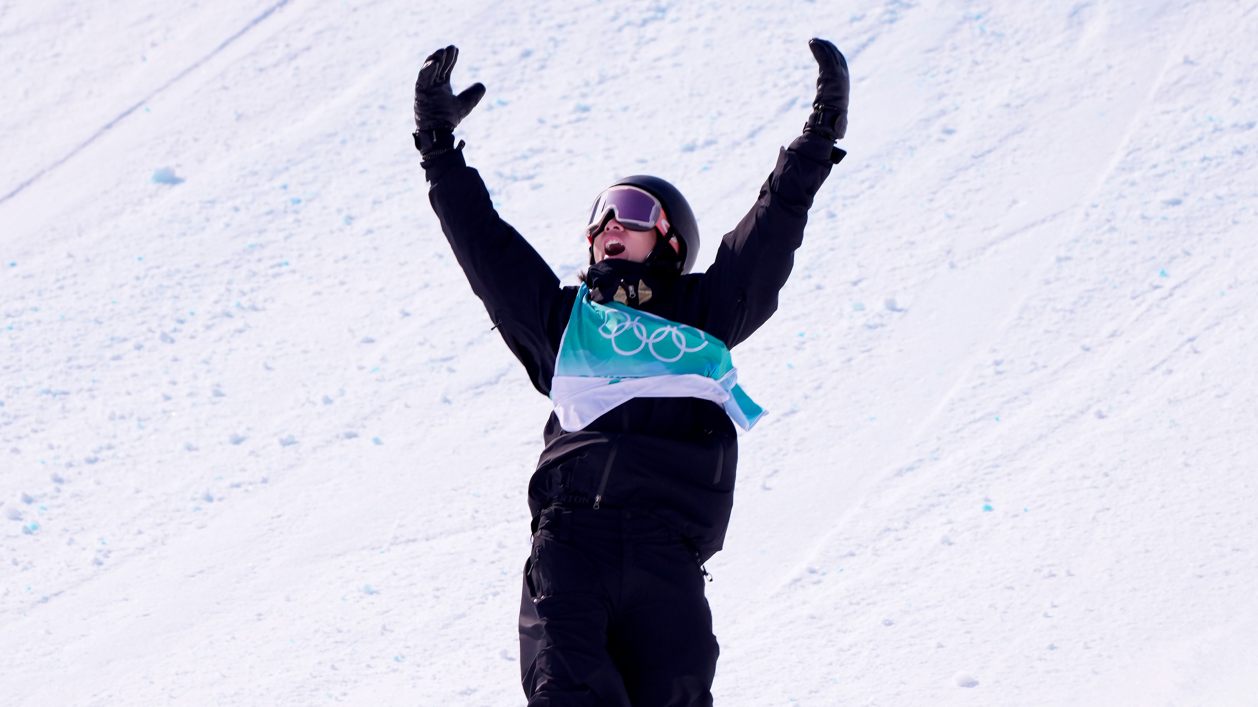 China's Yiming Su cheers as he comes into the end zone following his third run in the men's snowboarding big air final at the Beijing Olympic Winter Games in Beijing, Tuesday, Feb. 15, 2022. Su will take home the gold medal following his performance. (Paul Chiasson/The Canadian Press via AP)