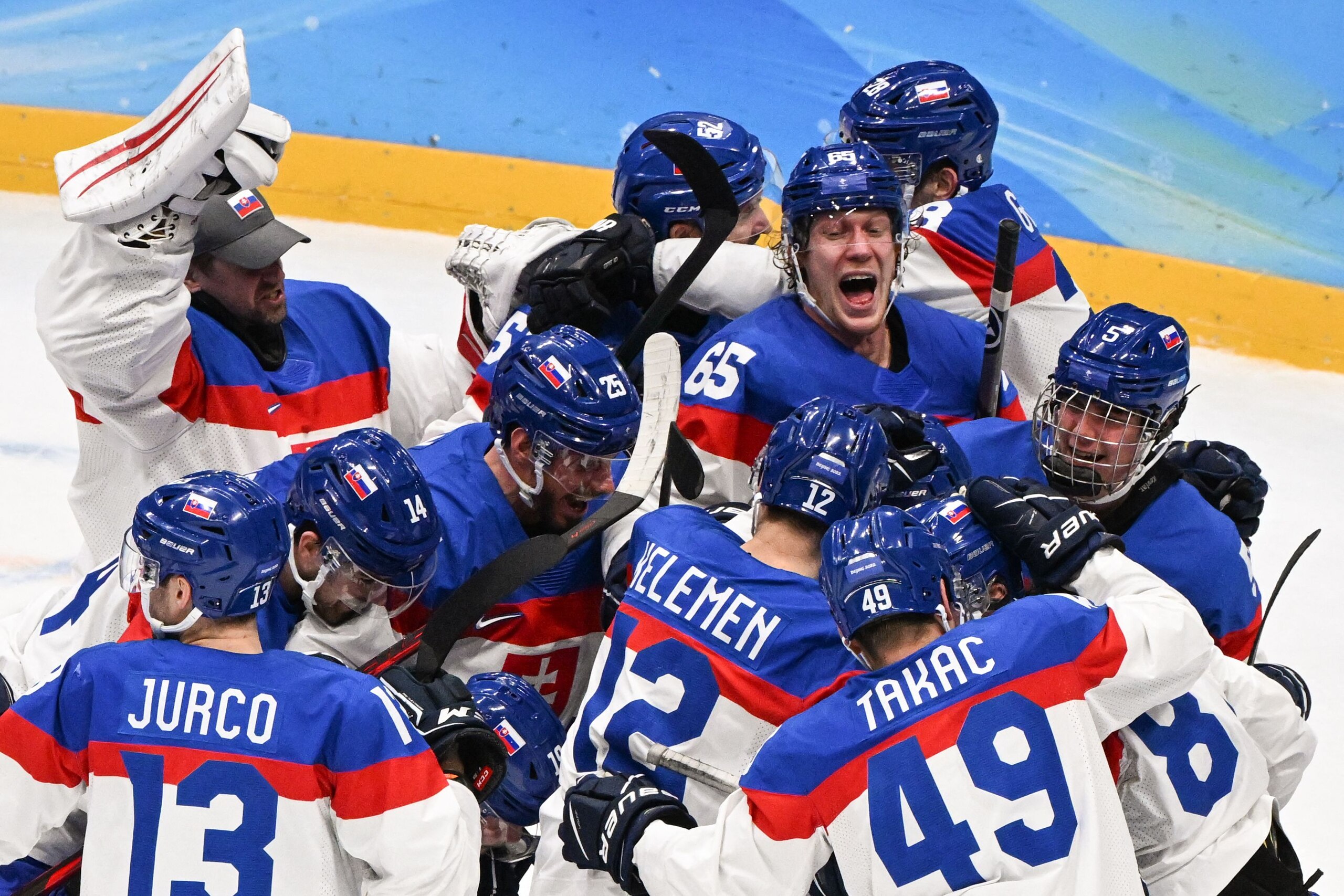 Slovakia's players celebrate victory during the men's play-off quarterfinal match of the Beijing 2022 Winter Olympic Games ice hockey competition between USA and Slovakia, at the National Indoor Stadium in Beijing on February 16, 2022. (Photo by ANTHONY WALLACE / AFP) (Photo by ANTHONY WALLACE/AFP via Getty Images)
