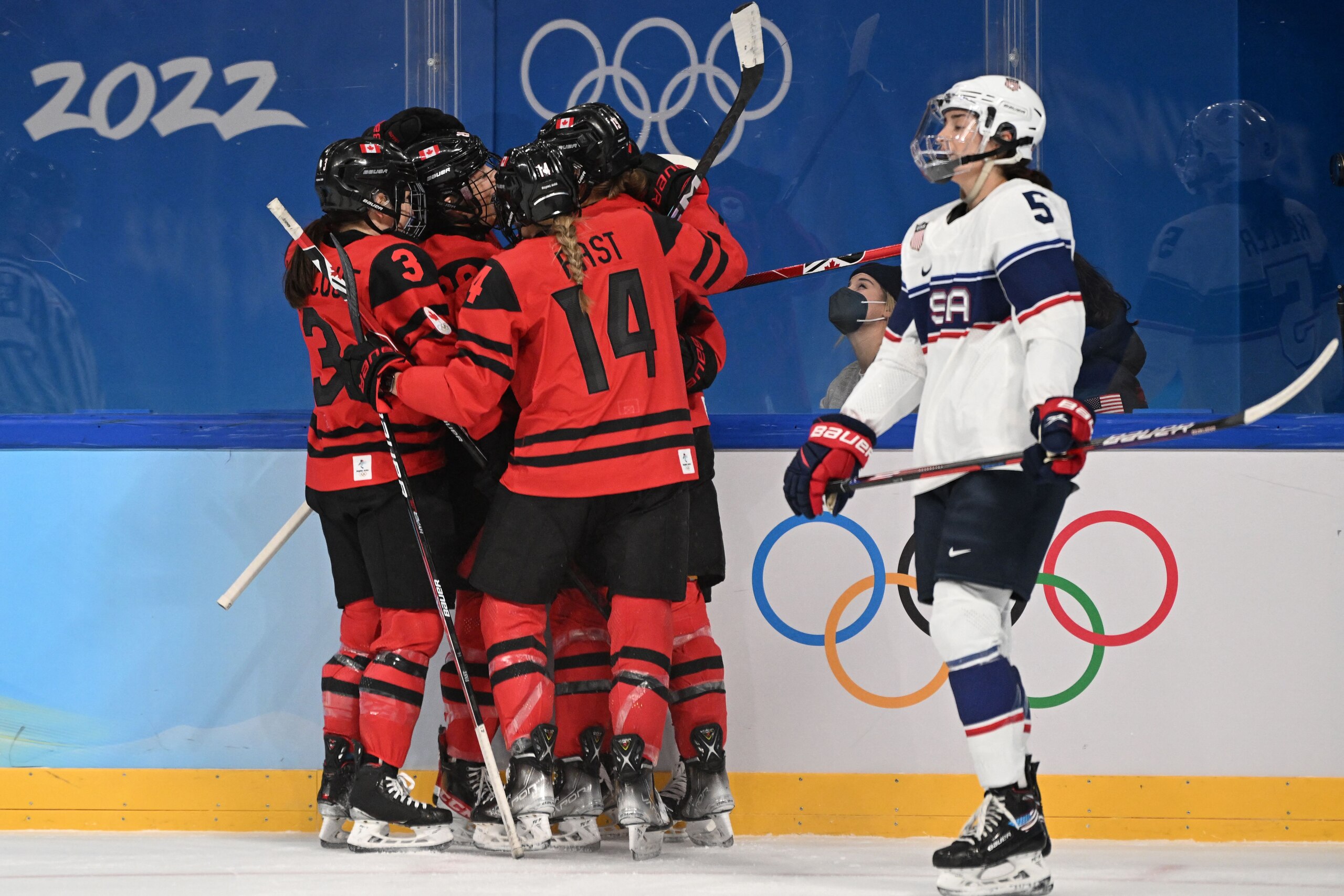 Canada's Marie-Philip Poulin (unseen) celebrates with teammates after scoring a goal during the women's gold medal match of the Beijing 2022 Winter Olympic Games ice hockey competition between Canada and USA, at the Wukesong Sports Centre in Beijing on February 17, 2022. (Photo by Kirill KUDRYAVTSEV / AFP) (Photo by KIRILL KUDRYAVTSEV/AFP via Getty Images)
