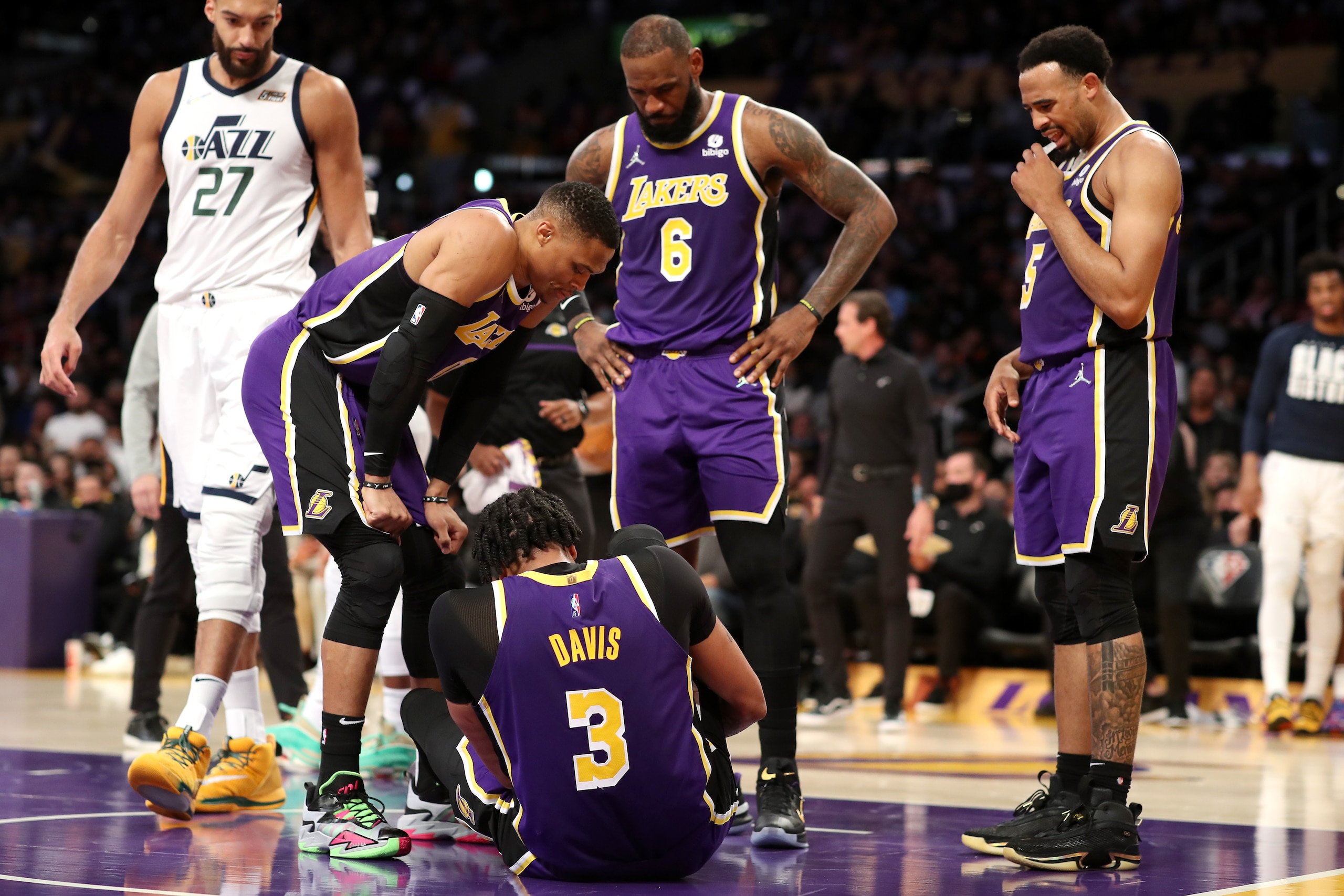 LOS ANGELES, CALIFORNIA - FEBRUARY 16: Russell Westbrook #0, LeBron James #6 and Talen Horton-Tucker #5 of the Los Angeles Lakers check up on teammate Anthony Davis #3 after an injury during the second quarter against the Utah Jazz at Crypto.com Arena on February 16, 2022 in Los Angeles, California. NOTE TO USER: User expressly acknowledges and agrees that, by downloading and or using this Photograph, user is consenting to the terms and conditions of the Getty Images License Agreement. (Photo by Katelyn Mulcahy/Getty Images)