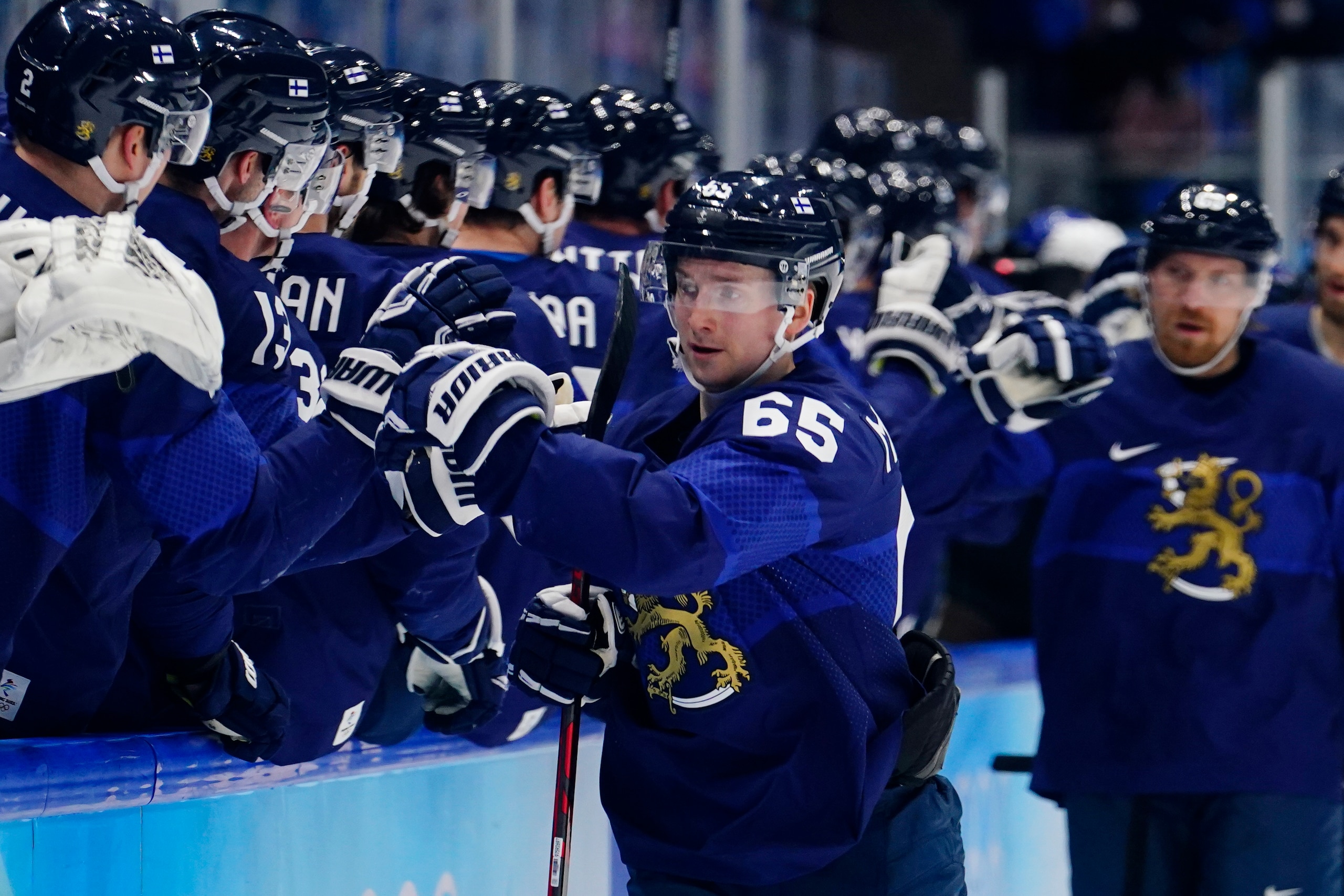 Finland's Sakari Manninen (65) is congratulated after scoring a goal against Slovakia during a men's semifinal hockey game at the 2022 Winter Olympics, Friday, Feb. 18, 2022, in Beijing. (AP Photo/Matt Slocum)