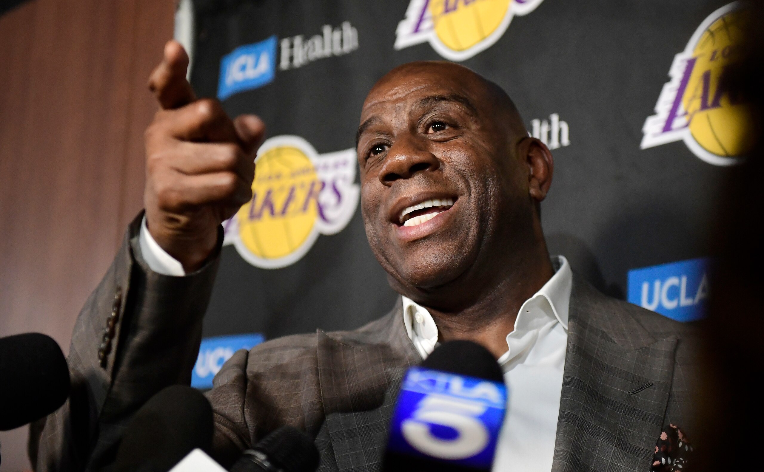 FILE - In this April 9, 2019, file photo, Magic Johnson speaks to reporters prior to an NBA basketball game between the Los Angeles Lakers and the Portland Trail Blazer in Los Angeles. Johnson might actually miss the Lakers if he was not always checking up on them. Johnson quit as the team's president of basketball operations at the end of the last season, leaving him out of a gym, but not out of the loop, as Los Angeles opened training camp. (AP Photo/Mark J. Terrill, File)