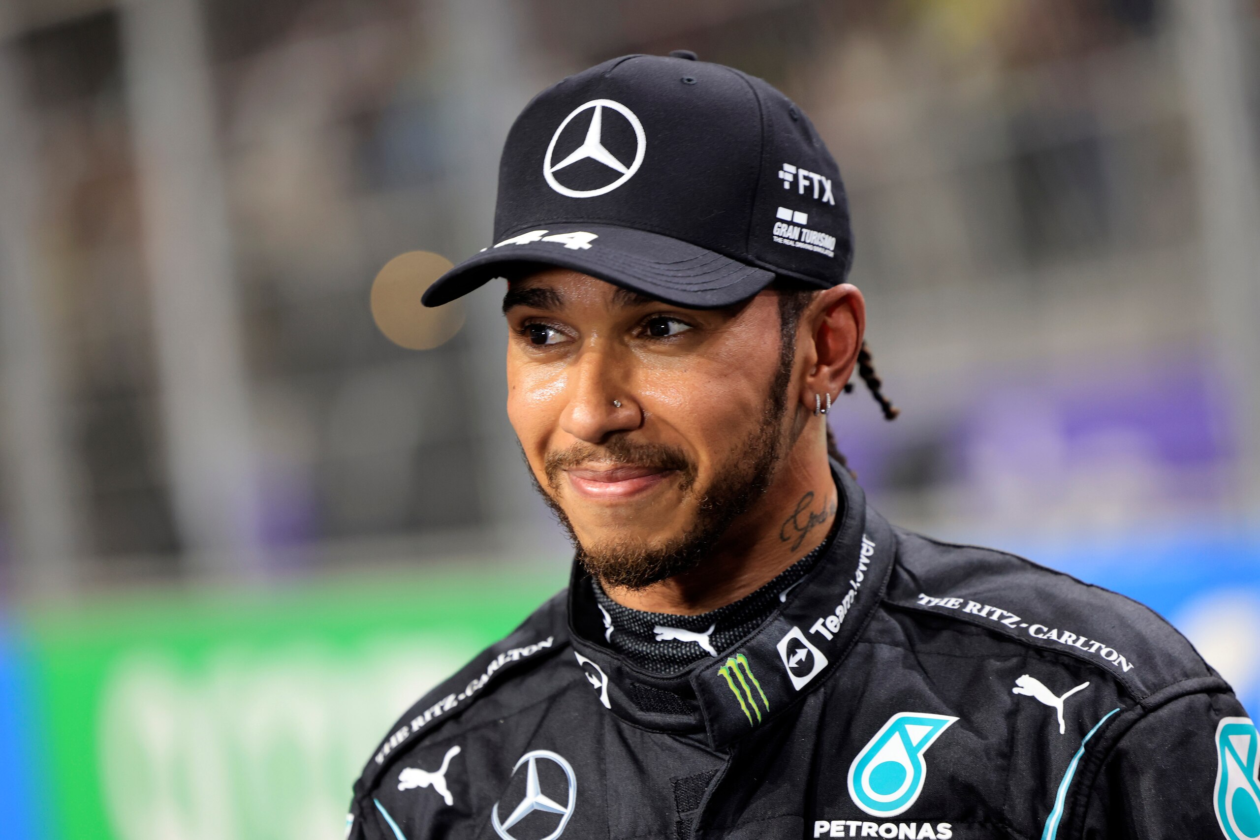 FILE- Mercedes driver Lewis Hamilton, of Britain smiles, after winning the pole position during qualifying for the Formula One Saudi Arabian Grand Prix auto race on Dec. 4, 2021, in Jiddah, Saudi Arabia. Hamilton returned to social media Saturday, Feb. 5, 2022, following a lengthy silence that dates to last season's controversial Formula 1 finale. (Giuseppe Cacace/Pool Photo via AP, File)