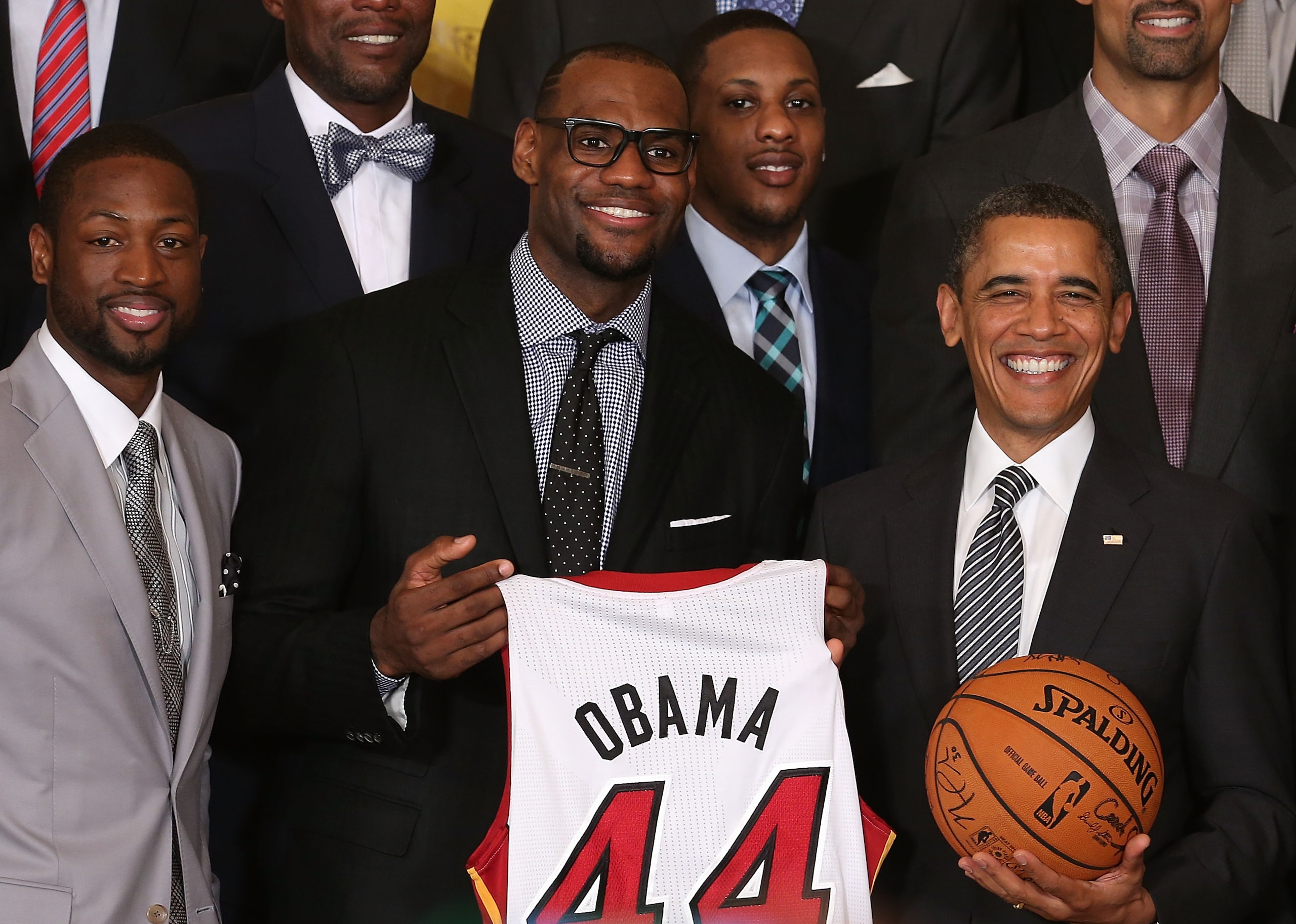 WASHINGTON, DC - JANUARY 28: U.S. President Barack Obama (R) stands with Miami Heat players, including Dwyane Wade (L), LeBron James (2nd-L), Mario Chalmers (2R) during an event to honor the NBA champion Miami Heat in the East Room at the White House on January 28, 2013 in Washington, DC. President Barack Obama congratulated the 2012 NBA champions for claiming their third NBA Championship by beating the Boston Celtics.  (Photo by Mark Wilson/Getty Images)