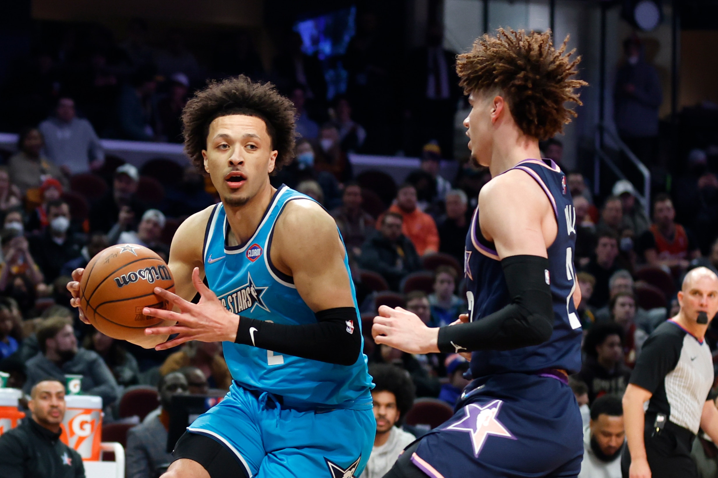 Team Barry's Cade Cunningham, of the Detroit Pistons, drives against Team Payton's LaMelo Ball, of the Charlotte Hornets, during a semifinal of the NBA basketball Rising Stars event, Friday, Feb. 18, 2022, in Cleveland. (AP Photo/Ron Schwane)