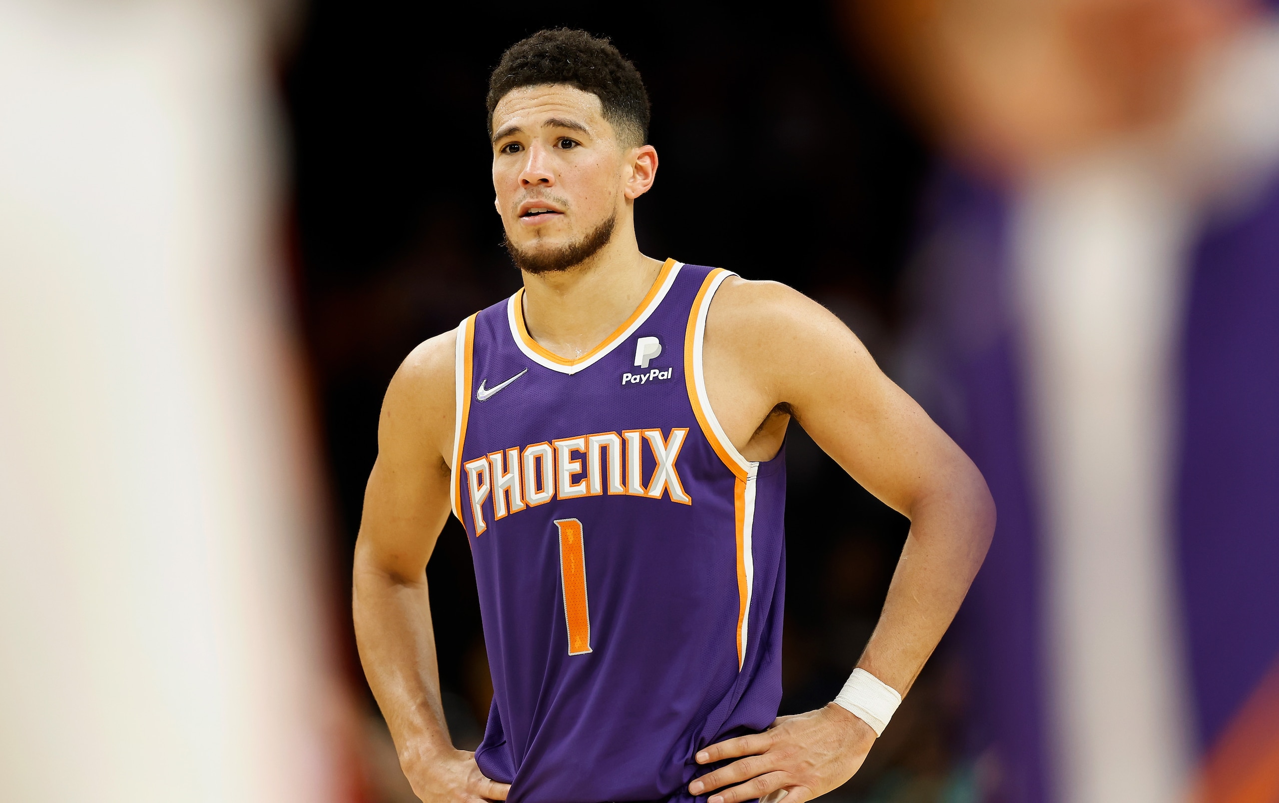 PHOENIX, ARIZONA - FEBRUARY 16:  Devin Booker #1 of the Phoenix Suns reacts during the second half of the NBA game against the Houston Rockets at Footprint Center on February 16, 2022 in Phoenix, Arizona. The Suns defeated the Rockets 124-121.  NOTE TO USER: User expressly acknowledges and agrees that, by downloading and or using this photograph, User is consenting to the terms and conditions of the Getty Images License Agreement. (Photo by Christian Petersen/Getty Images)