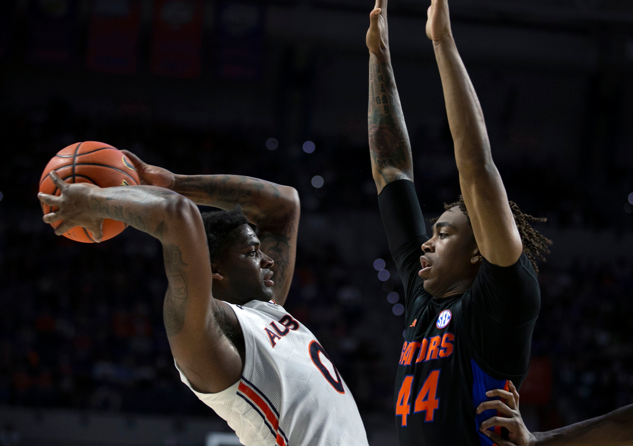Auburn guard K.D. Johnson (0) tries to shoot around Florida guard Niels Lane (44) during the first half of an NCAA college basketball game Saturday, Feb. 19, 2022, in Gainesville, Fla. (AP Photo/Alan Youngblood) Auburn guard K.D. Johnson (0) tries to shoot around Florida guard Niels Lane (44) during the first half of an NCAA college basketball game Saturday, Feb. 19, 2022, in Gainesville, Fla. (AP Photo/Alan Youngblood)
