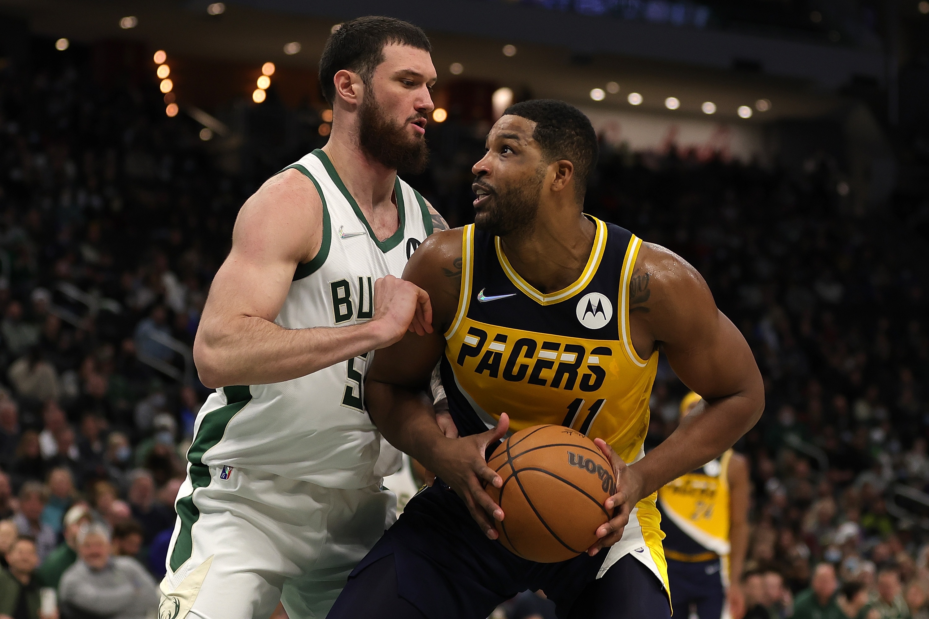 MILWAUKEE, WISCONSIN - FEBRUARY 15: Tristan Thompson #11 of the Indiana Pacers is defended by Sandro Mamukelashvili #54 of the Milwaukee Bucks during the second half of a game at Fiserv Forum on February 15, 2022 in Milwaukee, Wisconsin. NOTE TO USER: User expressly acknowledges and agrees that, by downloading and or using this photograph, User is consenting to the terms and conditions of the Getty Images License Agreement. (Photo by Stacy Revere/Getty Images)