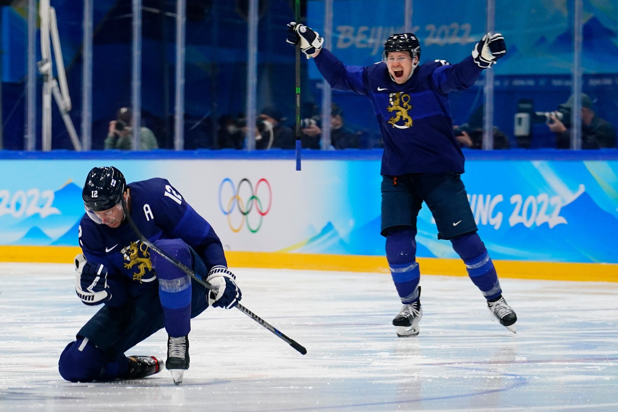 Finland's Marko Anttila (12) and Ville Pokka (2) celebrate a goal by teammate Hannes Bjorninen during the men's gold medal hockey game against Russian Olympic Committee at the 2022 Winter Olympics, Sunday, Feb. 20, 2022, in Beijing. (AP Photo/Matt Slocum)