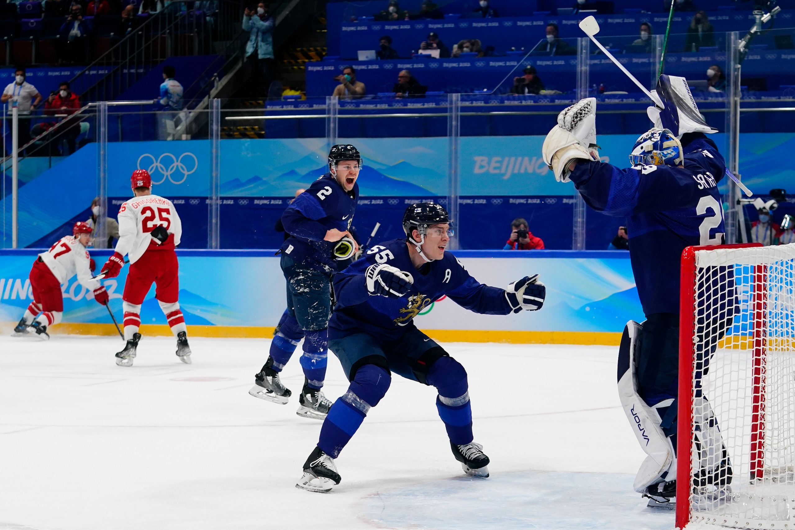 Finland's Atte Ohtamaa (55) and Ville Pokka (2) celebrate with goalkeeper Harri Sateri, right, after Finland defeated Russian Olympic Committee to win the men's gold medal hockey game at the 2022 Winter Olympics, Sunday, Feb. 20, 2022, in Beijing. (AP Photo/Matt Slocum)