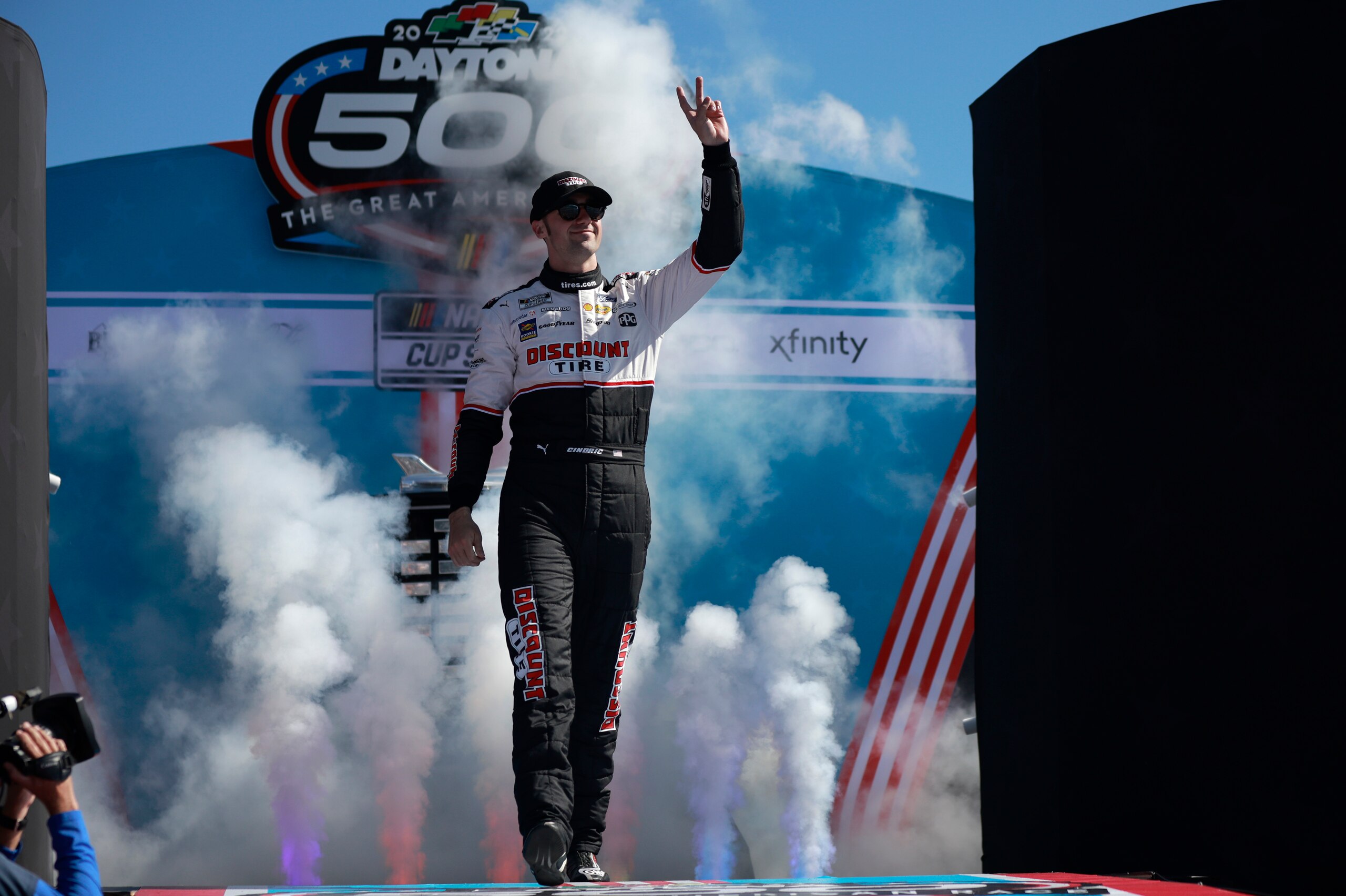 DAYTONA BEACH, FLORIDA - FEBRUARY 20: Austin Cindric, driver of the #2 Discount Tire Ford, waves to fans onstage during the driver intros prior to the NASCAR Cup Series 64th Annual Daytona 500 at Daytona International Speedway on February 20, 2022 in Daytona Beach, Florida. (Photo by Jared C. Tilton/Getty Images)