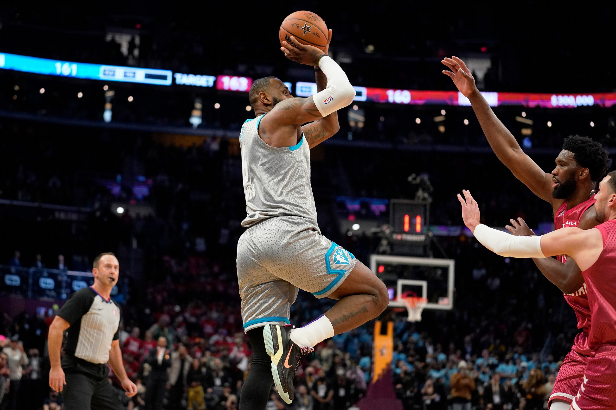Los Angeles Lakers' LeBron James, left, hits the game winning shot in the second half of the NBA All-Star basketball game, Sunday, Feb. 20, 2022, in Cleveland. (AP Photo/Charles Krupa)