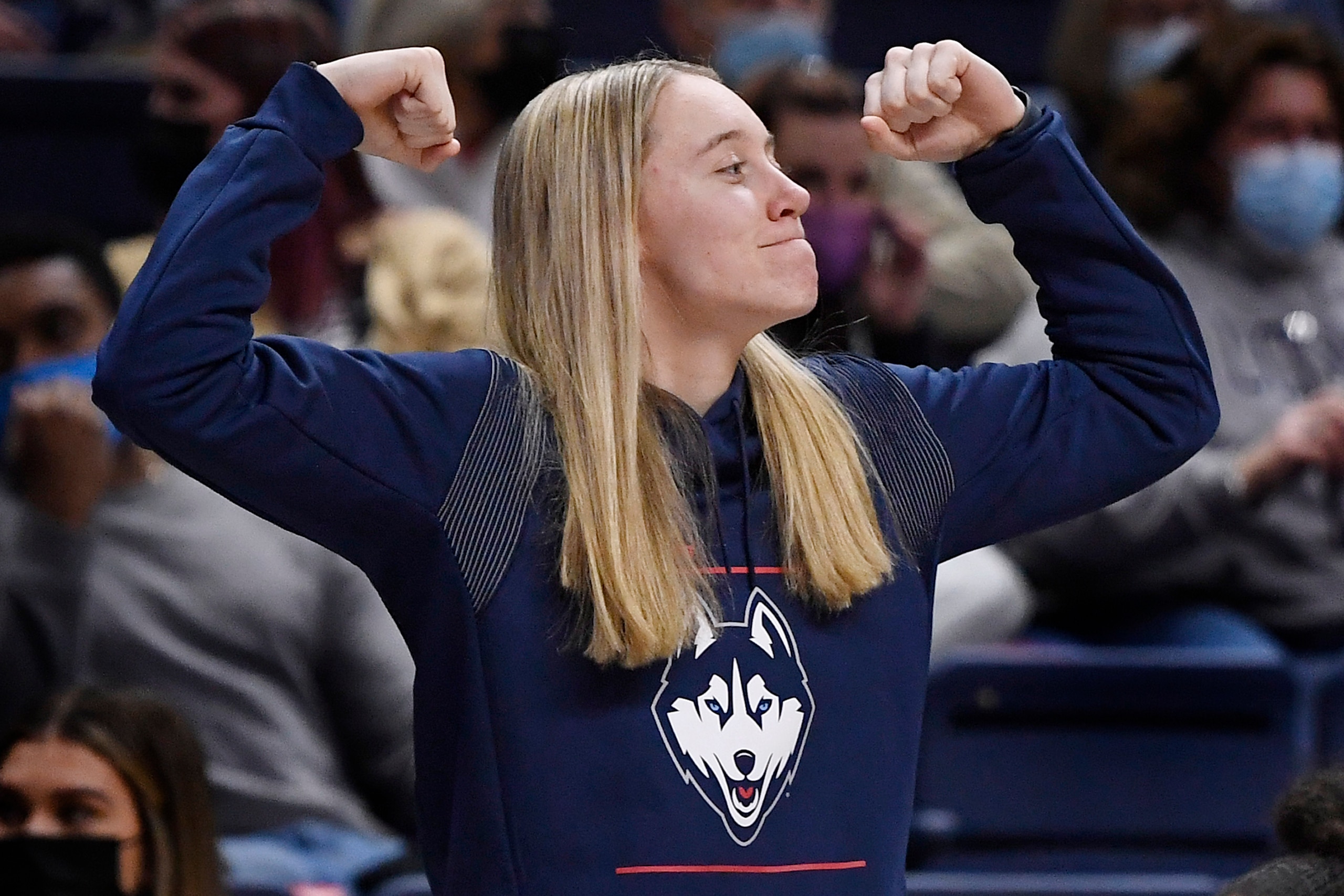 Connecticut's Paige Bueckers flexes from the bench in the second half of an NCAA college basketball game against Seton Hall, Friday, Jan. 21, 2022, in Storrs, Conn. (AP Photo/Jessica Hill)