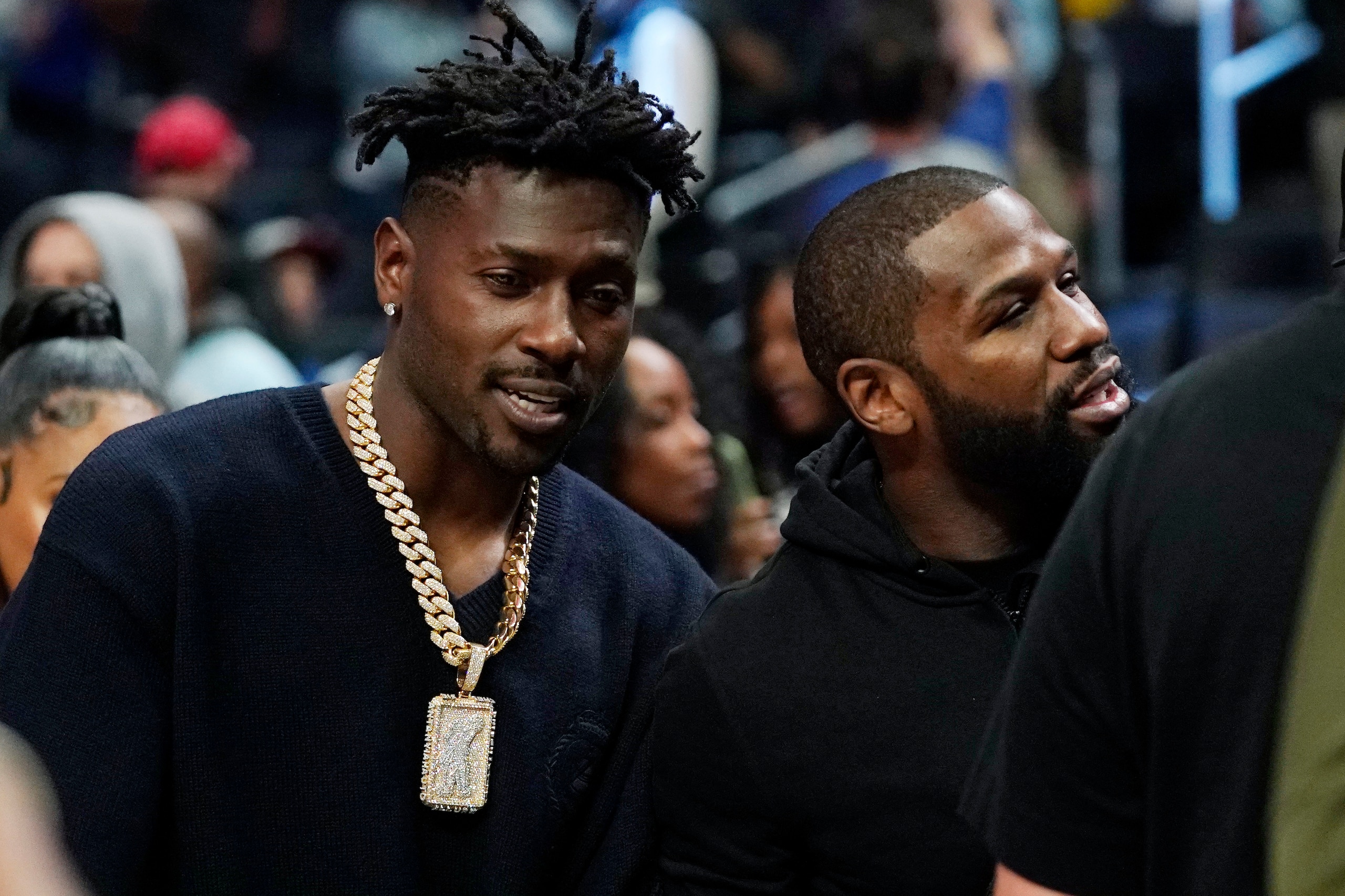 National Football League wide receiver Antonio Brown, left, is seen with boxer Floyd Mayweather at an NBA basketball game between the Los Angeles Clippers and the Golden State Warriors Monday, Feb. 14, 2022, in Los Angeles. (AP Photo/Mark J. Terrill)