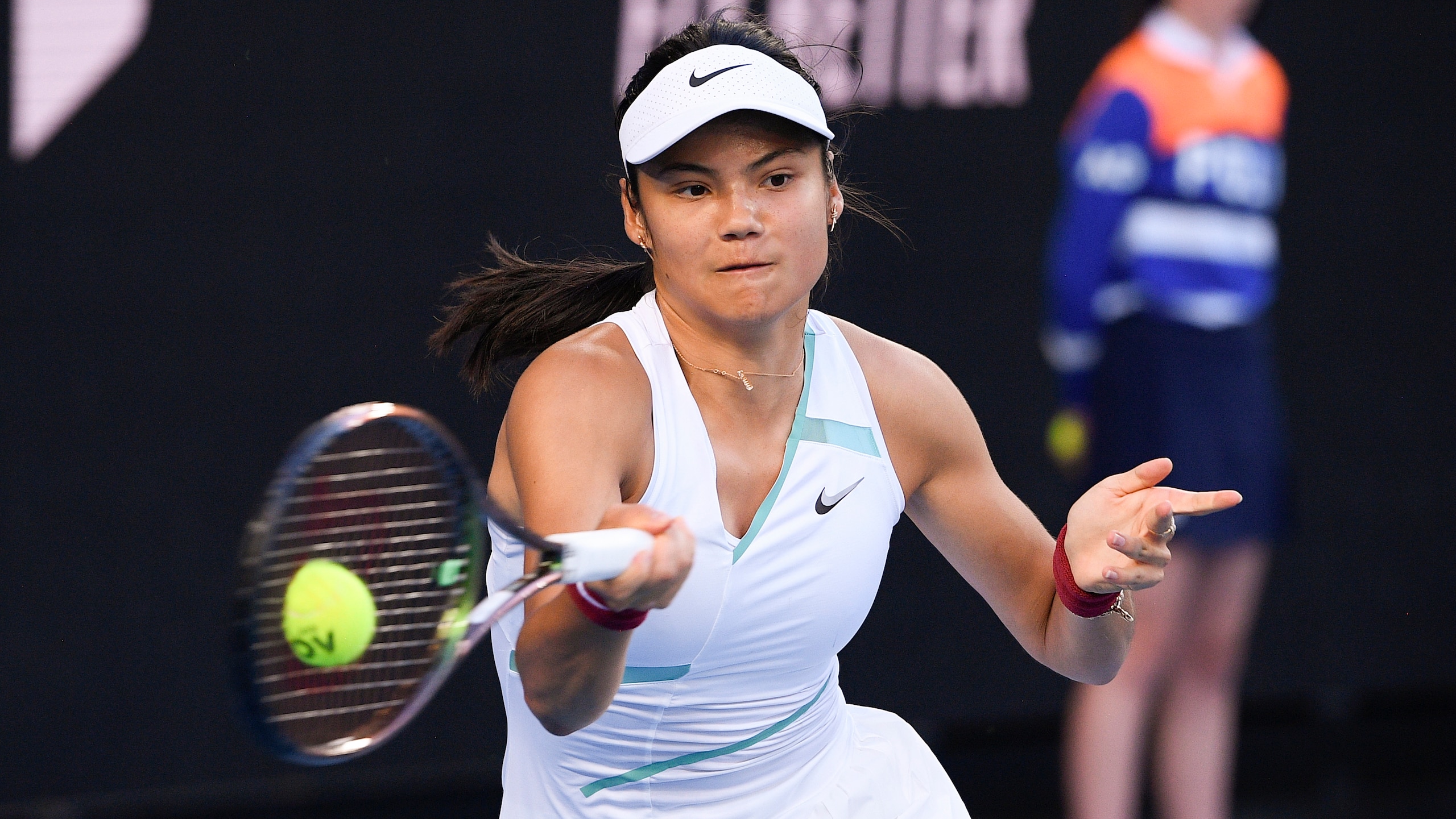 Emma Raducanu of Britain plays a forehand return to Danka Kovinic of Montenegro during their second round match at the Australian Open tennis championships in Melbourne, Australia, Thursday, Jan. 20, 2022. (AP Photo/Andy Brownbill)