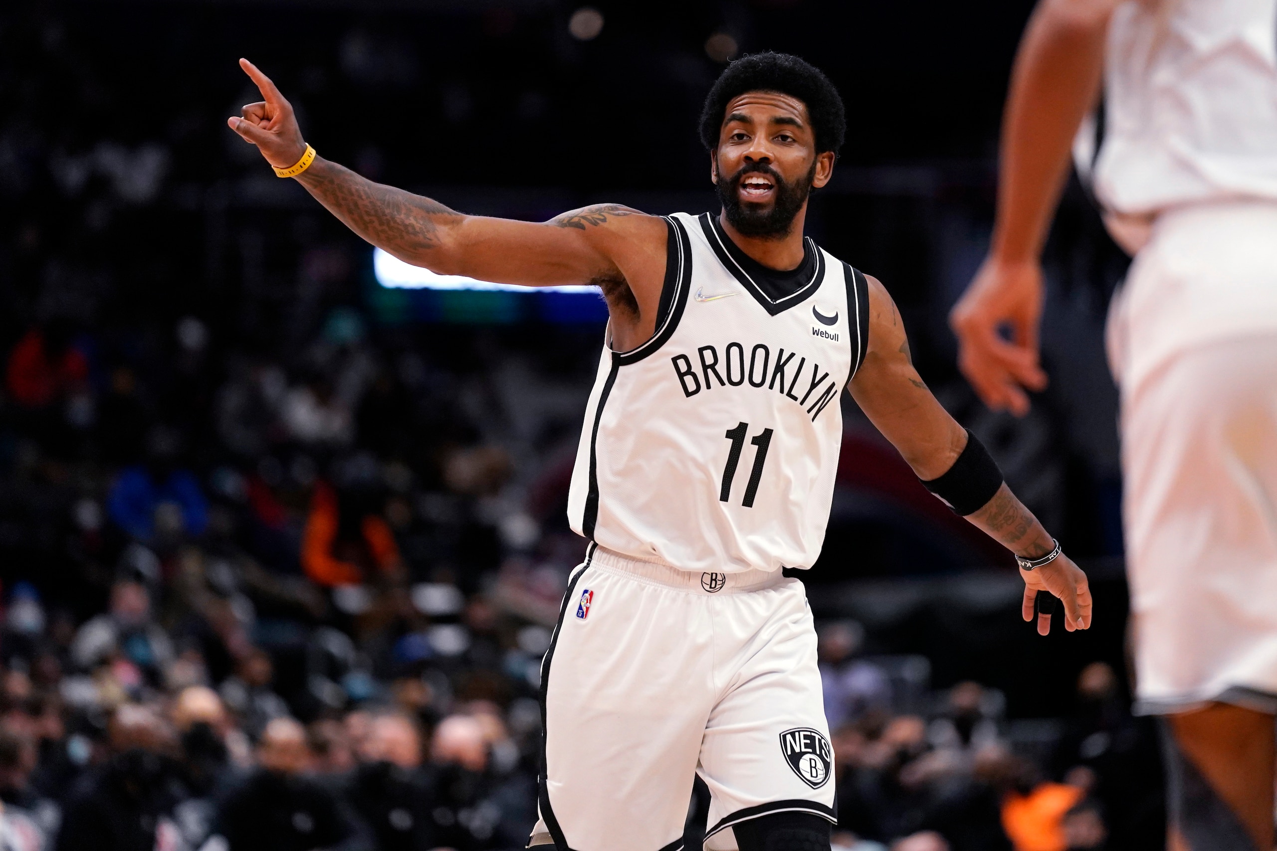 Brooklyn Nets guard Kyrie Irving shouts instructions to teammates during the first half of the team's NBA basketball game against the Washington Wizards, Thursday, Feb. 10, 2022, in Washington. (AP Photo/Evan Vucci)