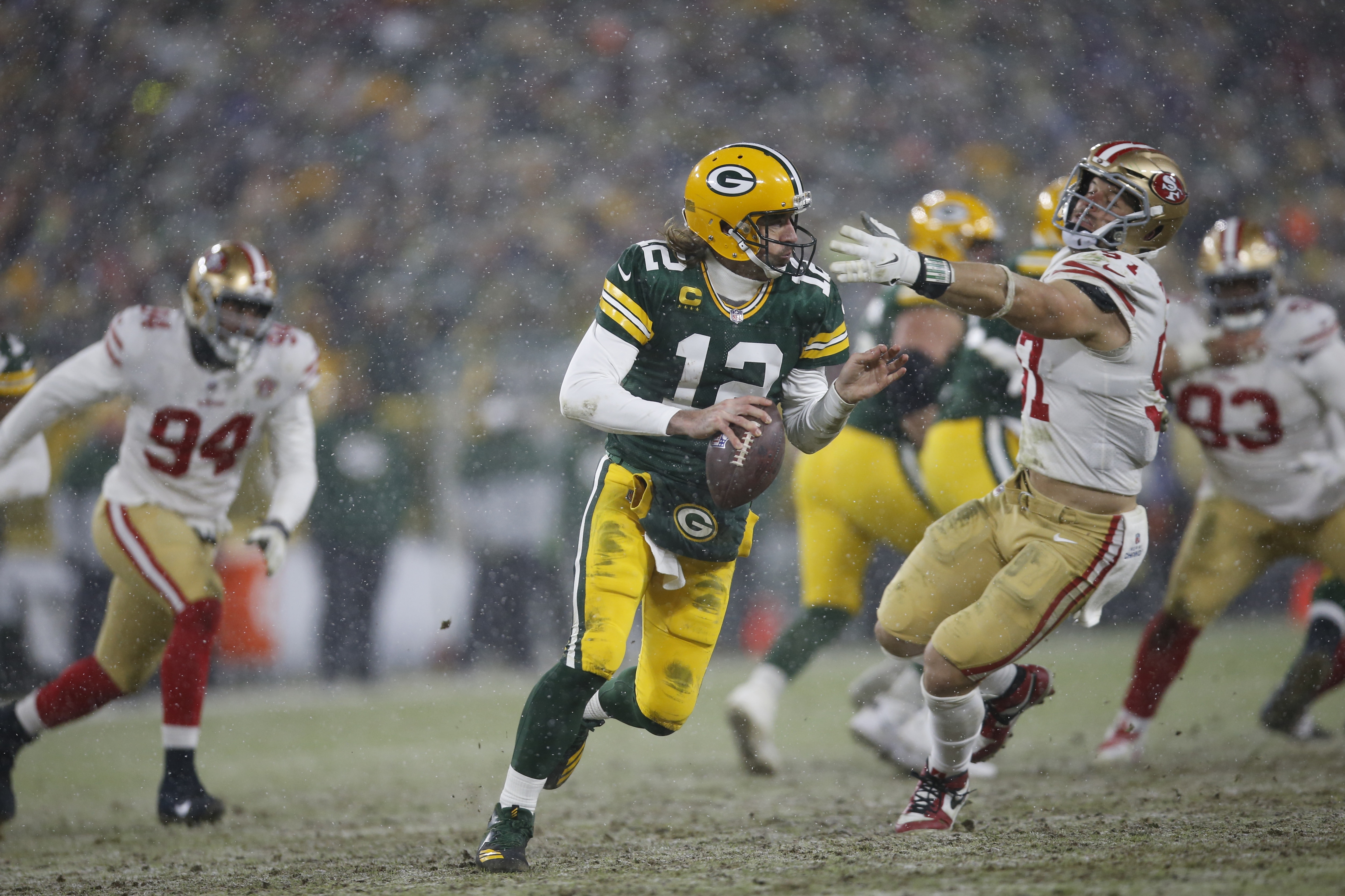 GREEN BAY, WISCONSIN - JANUARY 22: Aaron Rodgers #12 of the Green Bay Packers scrambles during the game against the San Francisco 49ers in the NFC Divisional Playoff game at Lambeau Field on January 22, 2022 in Green Bay, Wisconsin. The 49ers defeated the Packers 13-10. (Photo by Michael Zagaris/San Francisco 49ers/Getty Images)