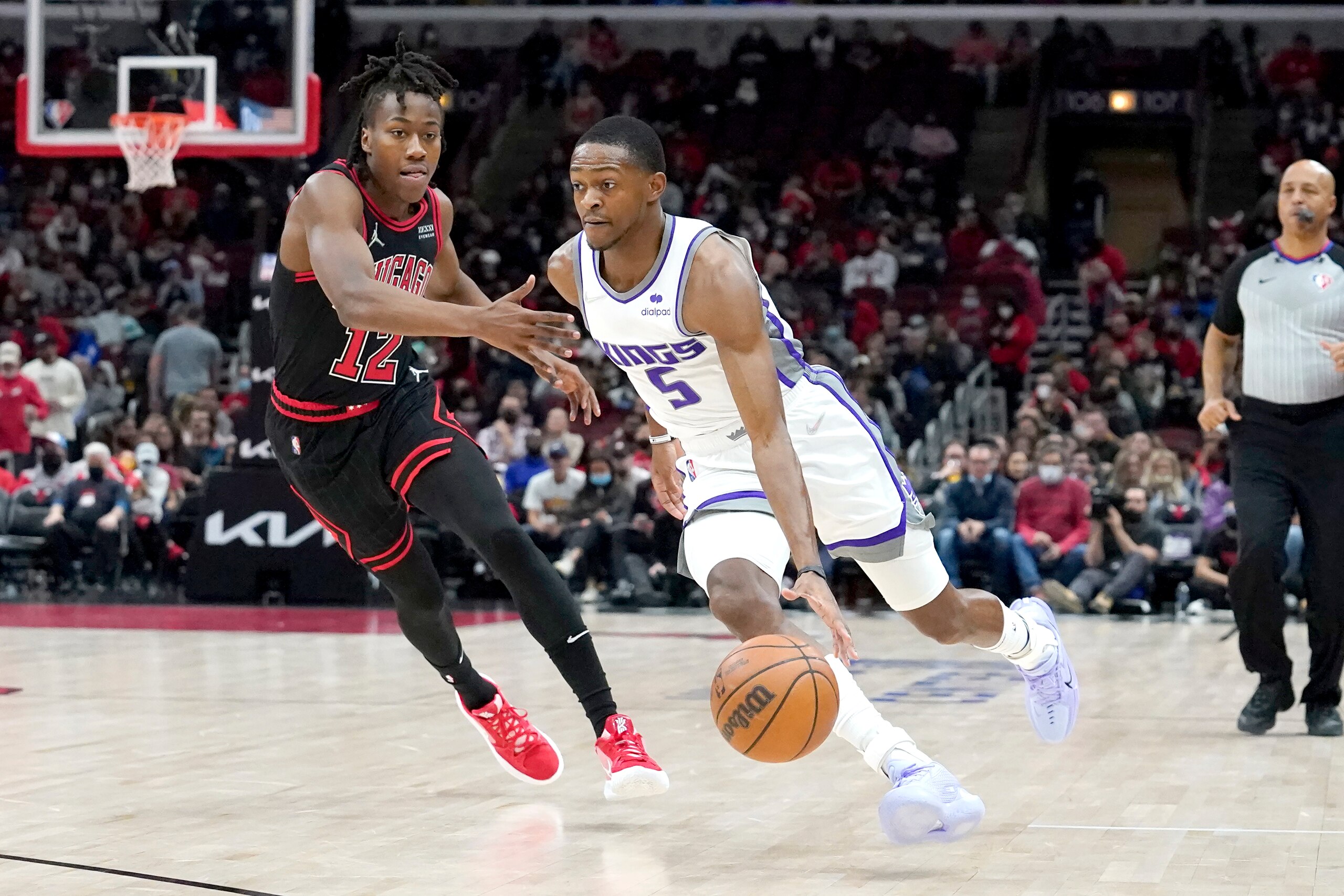 Sacramento Kings' De'Aaron Fox, right, drives on Chicago Bulls' Ayo Dosunmu during the first half of an NBA basketball game Wednesday, Feb. 16, 2022, in Chicago. (AP Photo/Charles Rex Arbogast) Sacramento Kings' De'Aaron Fox, right, drives on Chicago Bulls' Ayo Dosunmu during the first half of an NBA basketball game Wednesday, Feb. 16, 2022, in Chicago. (AP Photo/Charles Rex Arbogast)