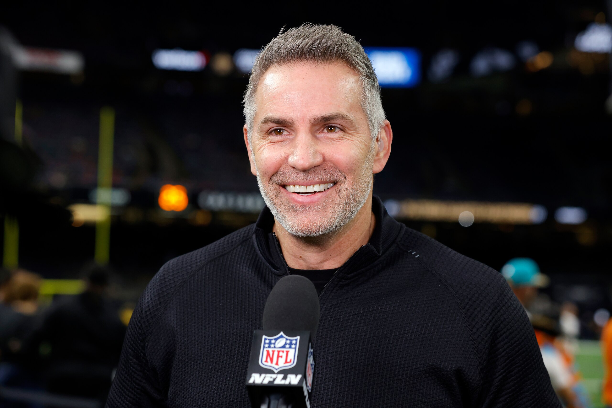 NFL Network reporter Kurt Warner is seen on the sidelines before an NFL football game between the New Orleans Saints and the Miami Dolphins, Monday, Dec. 27, 2021, in New Orleans. (AP Photo/Tyler Kaufman)