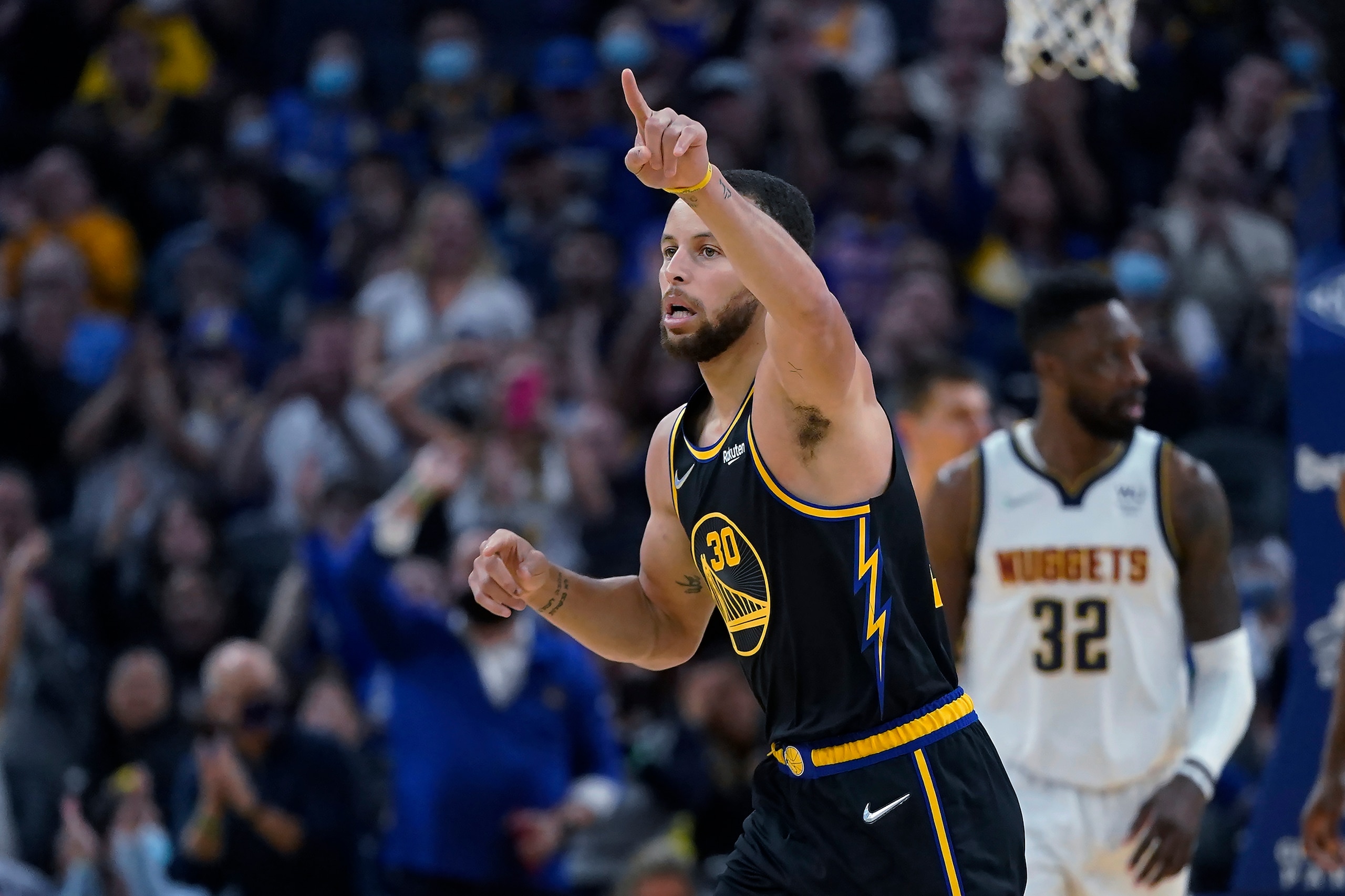Golden State Warriors guard Stephen Curry celebrates after making a 3-point basket against the Denver Nuggets during the first half of an NBA basketball game in San Francisco, Wednesday, Feb. 16, 2022. (AP Photo/Jeff Chiu)