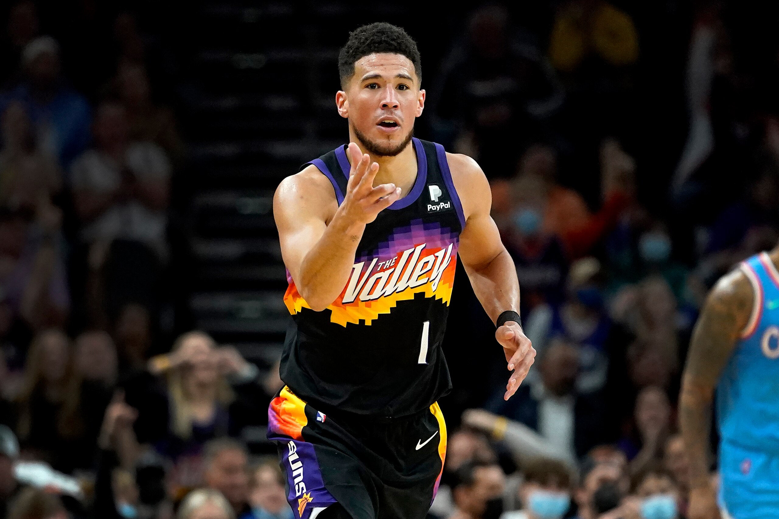 Phoenix Suns guard Devin Booker (1) motions after making a three pointer against the Los Angeles Clippers during the second half of an NBA basketball game Tuesday, Feb. 15, 2022, in Phoenix. The Suns won 103-96. (AP Photo/Matt York)