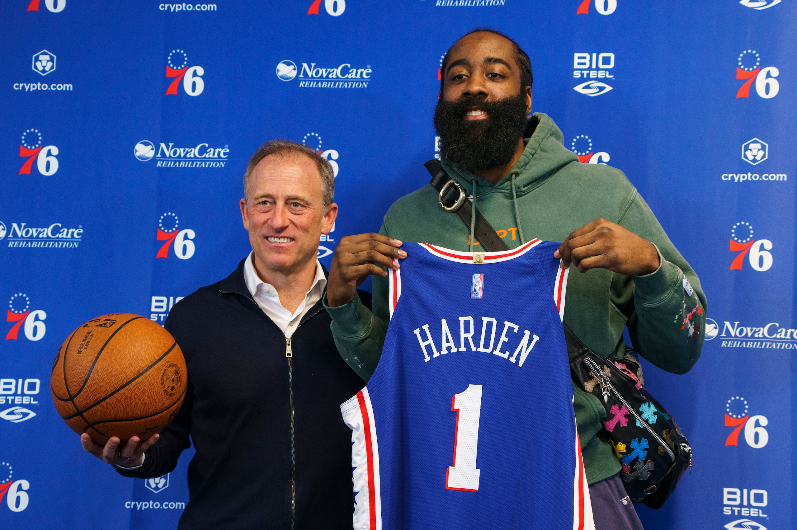Philadelphia 76ers' James Harden, right, and owner Joshua Harris, left, poses for photos following a press conference at the NBA basketball team's facility, Tuesday, Feb. 15, 2022, in Camden, N.J. (AP Photo/Chris Szagola)
