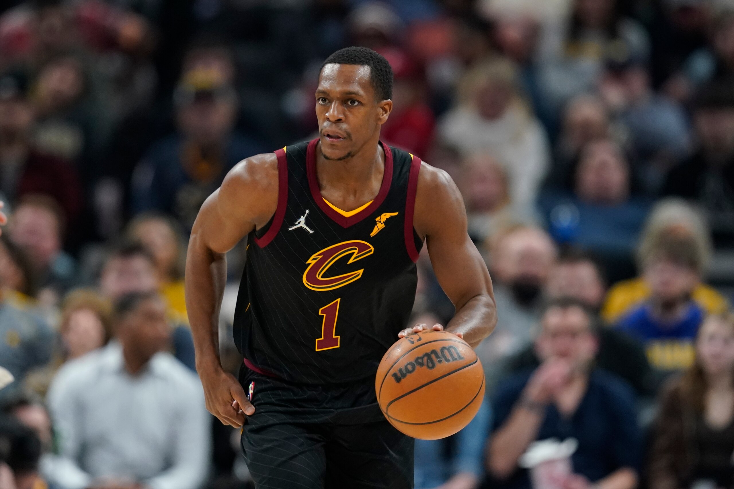 Cleveland Cavaliers' Rajon Rondo (1) dribbles during the first half of an NBA basketball game against the Indiana Pacers, Friday, Feb. 11, 2022, in Indianapolis. Cleveland won 120-113. (AP Photo/Darron Cummings)