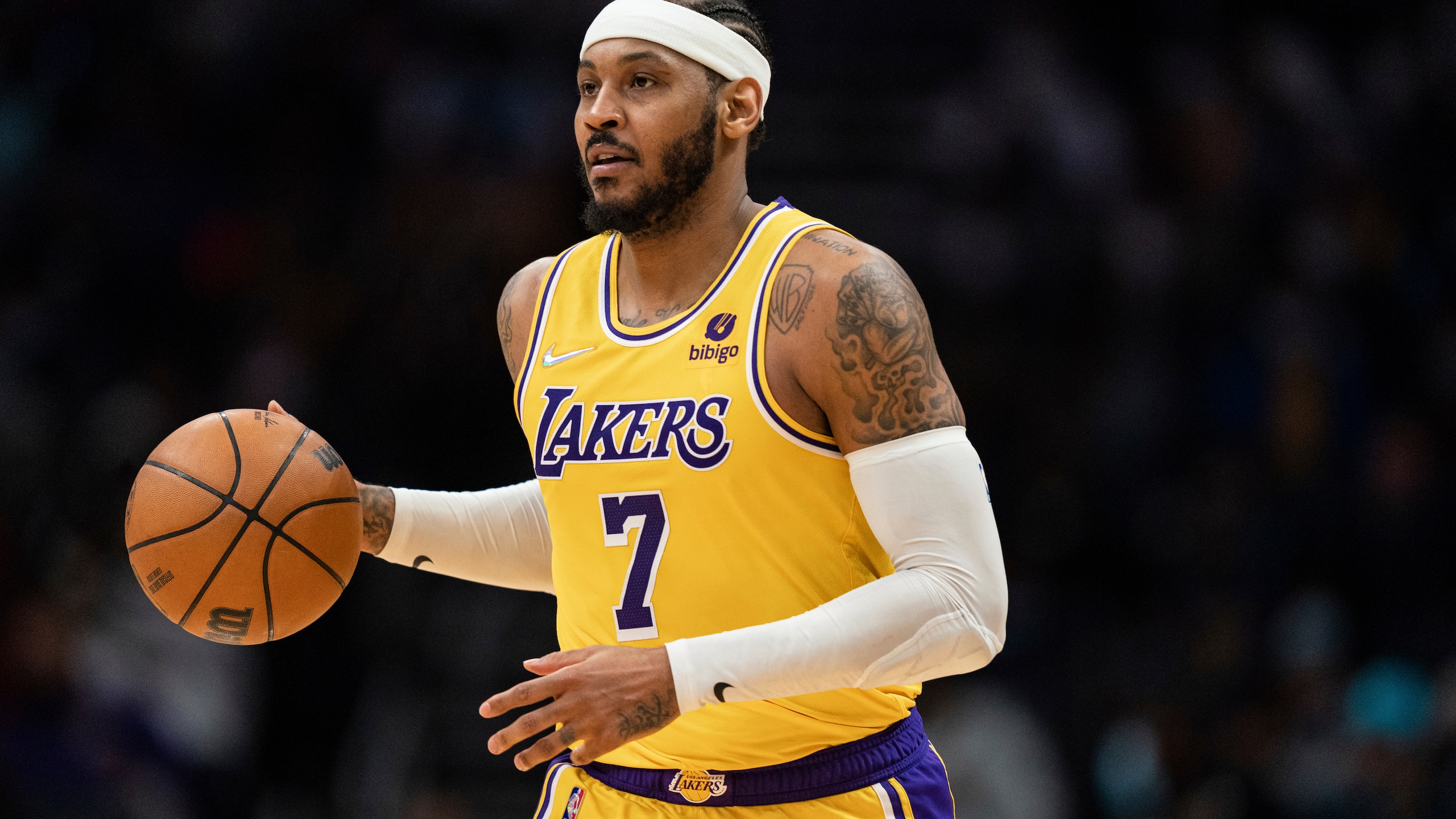 Los Angeles Lakers forward Carmelo Anthony (7) brings the ball up court against the Charlotte Hornets during the second half of an NBA basketball game in Charlotte, N.C., Friday, Jan. 28, 2022. (AP Photo/Jacob Kupferman)