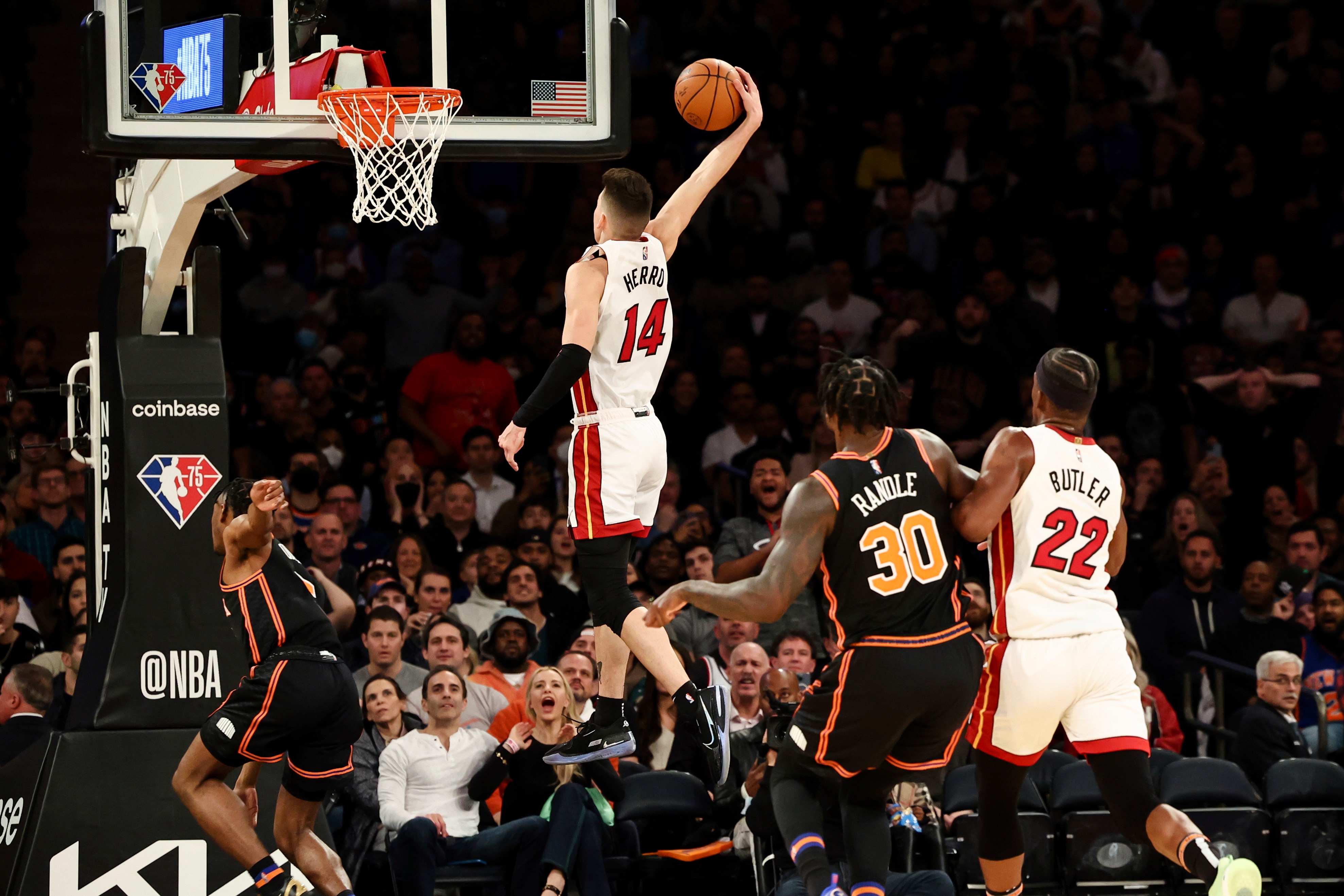 Miami Heat guard Tyler Herro (14) goes up to dunk as New York Knicks forward Julius Randle (30) and Heat forward Jimmy Butler (22) look on during the second half of an NBA basketball game, Friday, Feb. 25, 2022, in New York. (AP Photo/Jessie Alcheh) Miami Heat guard Tyler Herro (14) goes up to dunk as New York Knicks forward Julius Randle (30) and Heat forward Jimmy Butler (22) look on during the second half of an NBA basketball game, Friday, Feb. 25, 2022, in New York. (AP Photo/Jessie Alcheh)