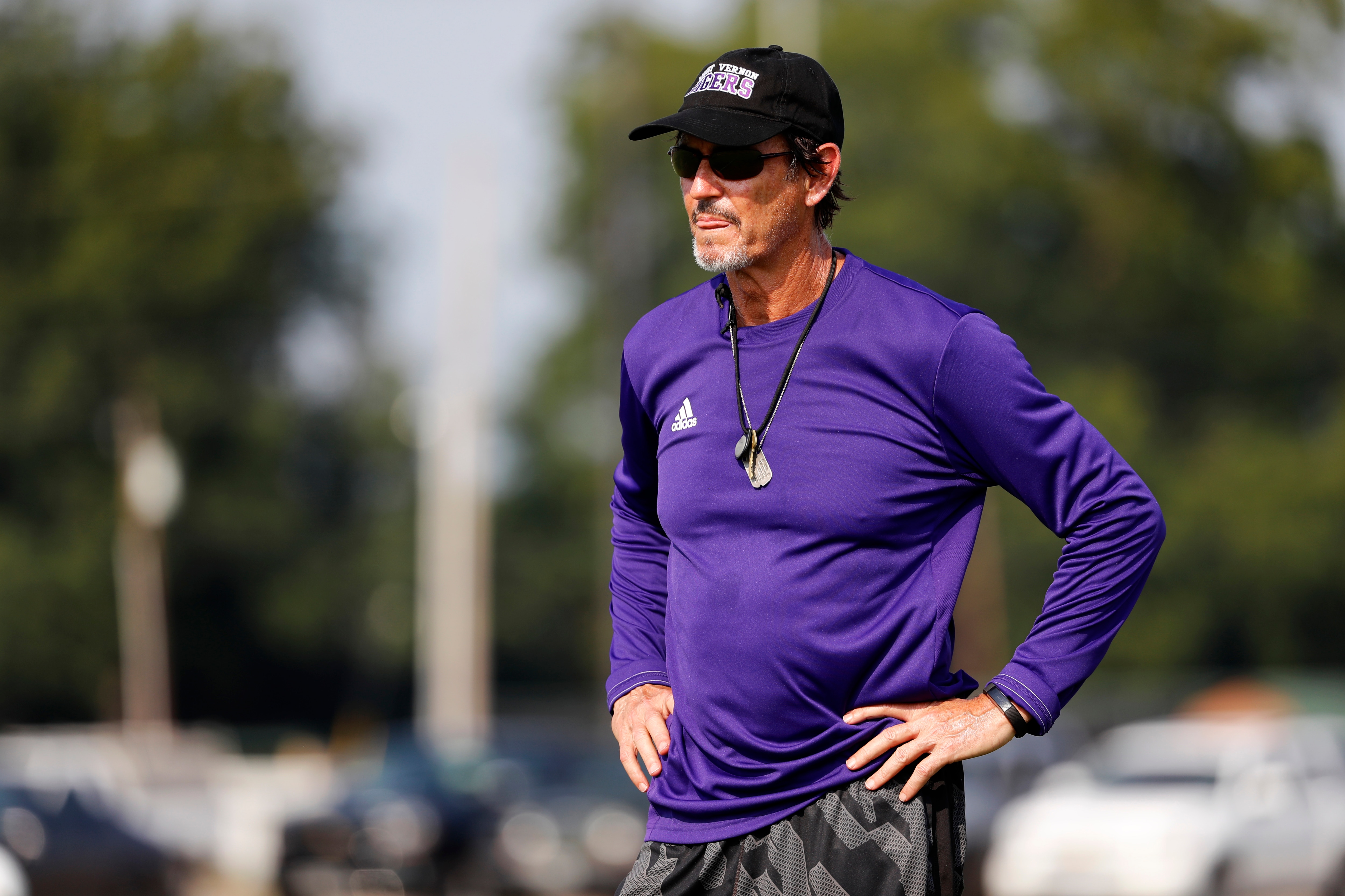 Coach Art Briles watches his team practice at Mount Vernon High School, Monday, Aug. 5, 2019, in Mount Vernon, Texas. Briles was back at his roots Monday, coaching a high school football team in Texas after a season in Italy and more than three years after the two-time Big 12 champion coach was fired by Baylor in the wake of a sexual assault scandal. (AP Photo/Tony Gutierrez)