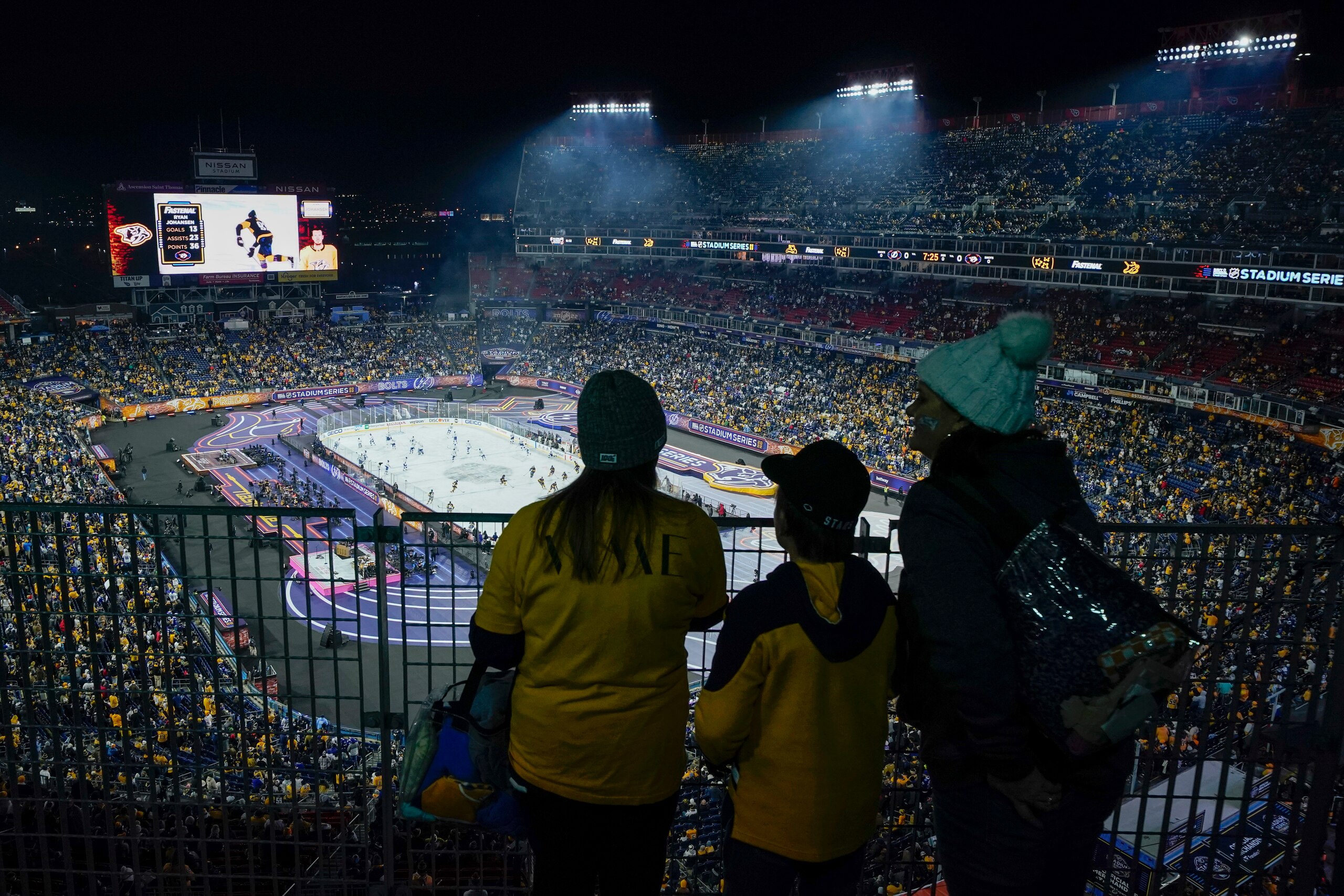 Fans watch as players warm up at Nissan Stadium before an NHL Stadium Series hockey game between the Nashville Predators and the Tampa Bay Lightning Saturday, Feb. 26, 2022, in Nashville, Tenn. (AP Photo/Mark Humphrey)