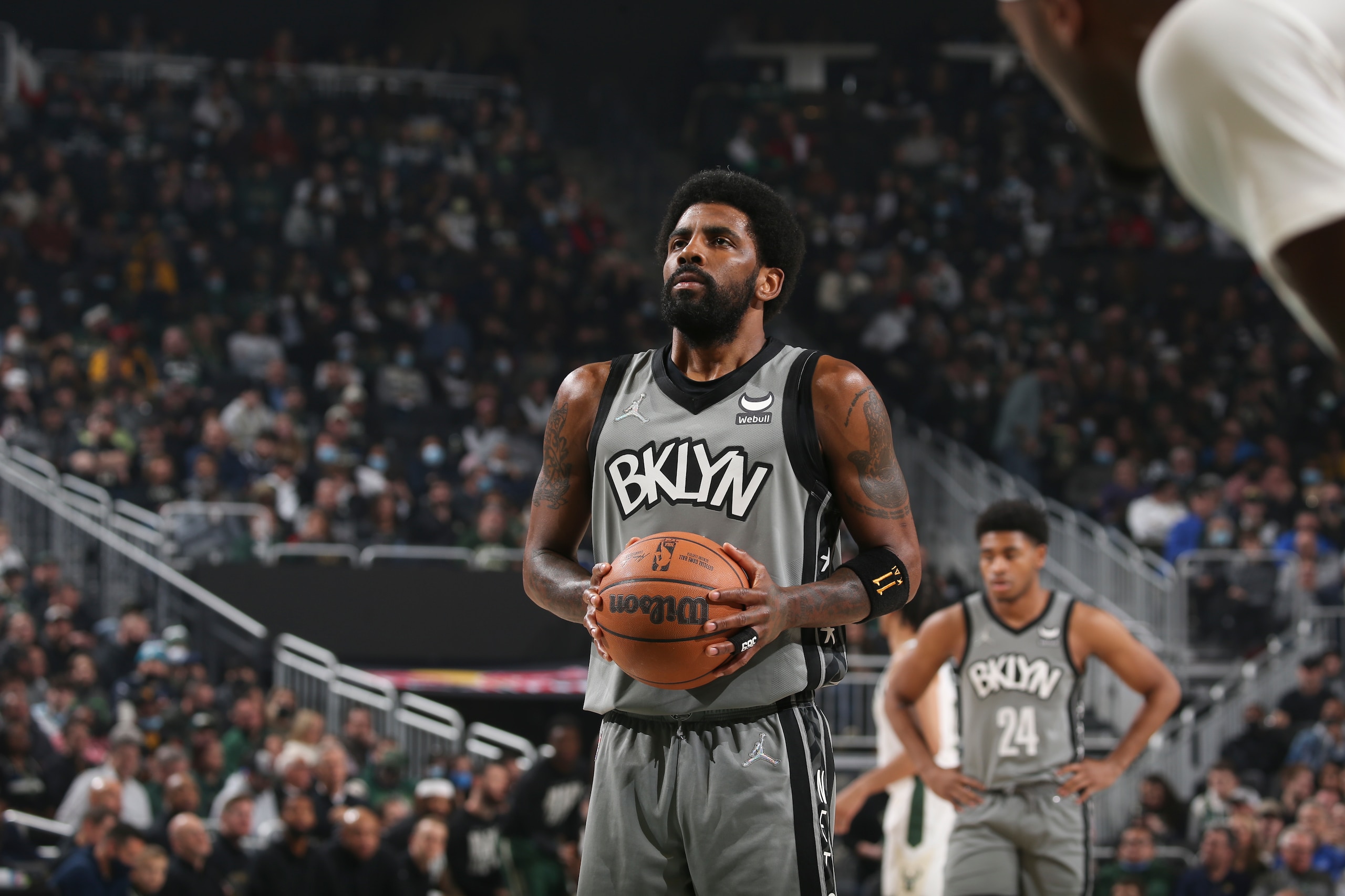 MILWAUKEE, WI - FEBRUARY 26: Kyrie Irving #11 of the Brooklyn Nets shoots a free throw during the game against the Milwaukee Bucks on February 26, 2022 at the Fiserv Forum Center in Milwaukee, Wisconsin. NOTE TO USER: User expressly acknowledges and agrees that, by downloading and or using this Photograph, user is consenting to the terms and conditions of the Getty Images License Agreement. Mandatory Copyright Notice: Copyright 2022 NBAE (Photo by Gary Dineen/NBAE via Getty Images).
