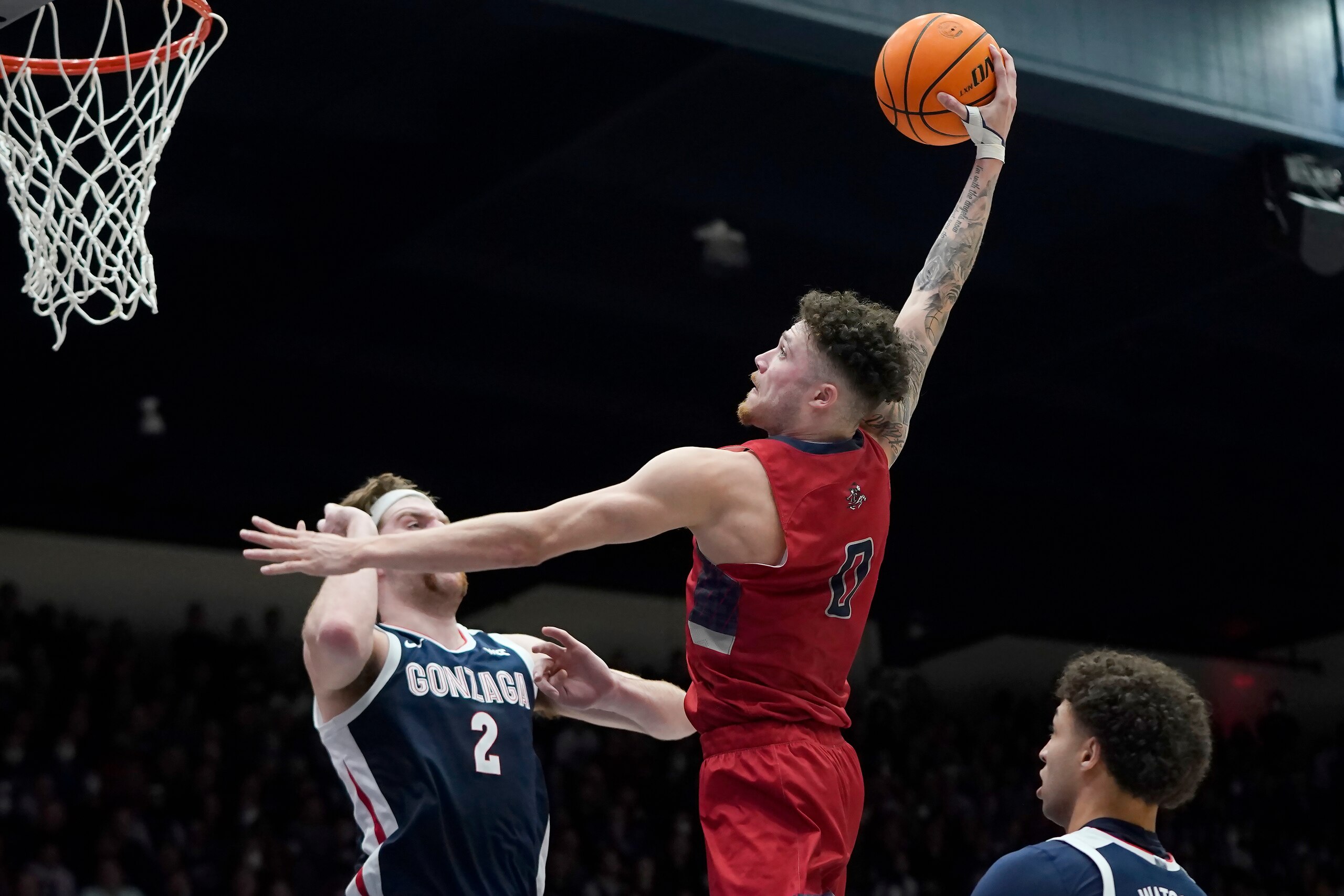 Saint Mary's guard Logan Johnson (0) dunks against Gonzaga forward Drew Timme (2) during the second half of an NCAA college basketball game in Moraga, Calif., Saturday, Feb. 26, 2022. (AP Photo/Jeff Chiu)