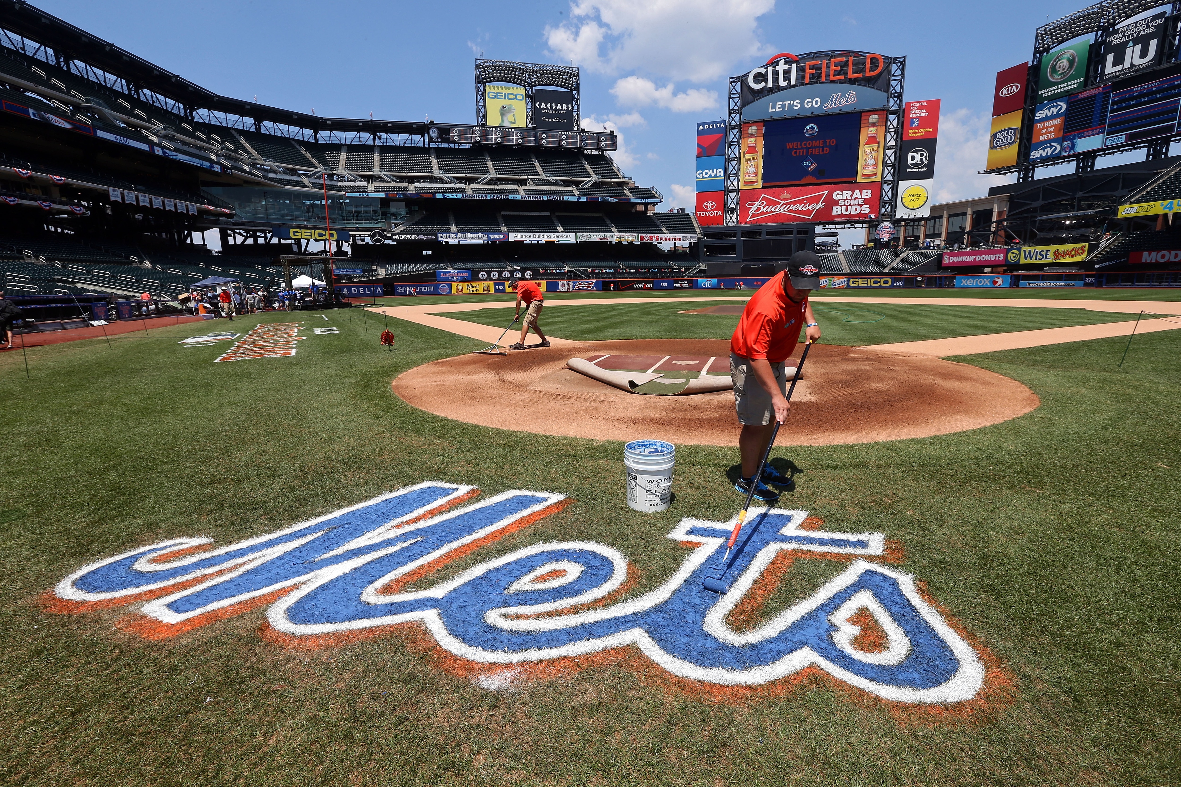 NEW YORK, NY - JULY 16: A  grounds crew member paints the Mets logo on the field during the 84th MLB All-Star Game on July 16, 2013 at Citi Field in the Flushing neighborhood of the Queens borough of New York City.  (Photo by Bruce Bennett/Getty Images)