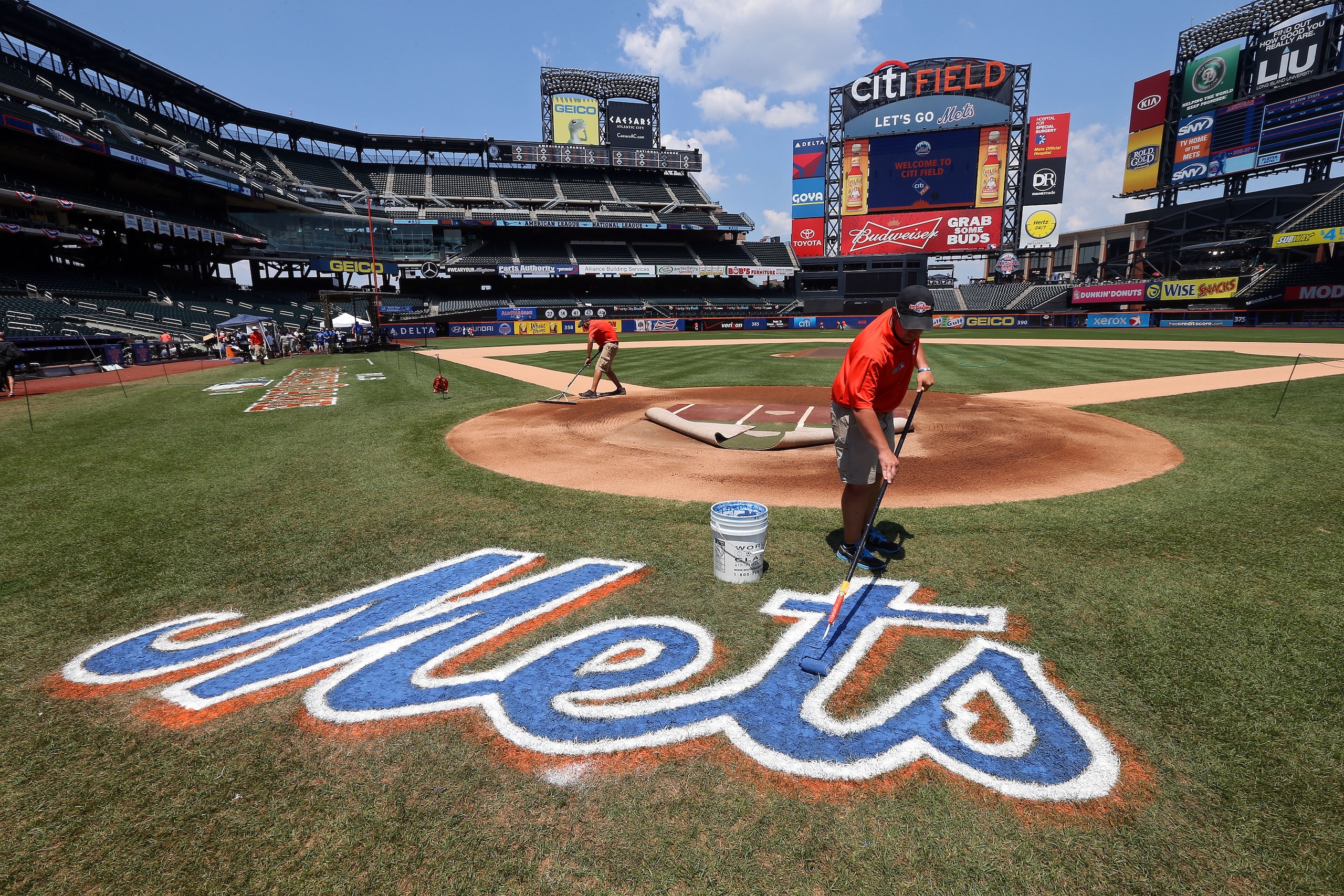 NEW YORK, NY - JULY 16: A  grounds crew member paints the Mets logo on the field during the 84th MLB All-Star Game on July 16, 2013 at Citi Field in the Flushing neighborhood of the Queens borough of New York City.  (Photo by Bruce Bennett/Getty Images)
