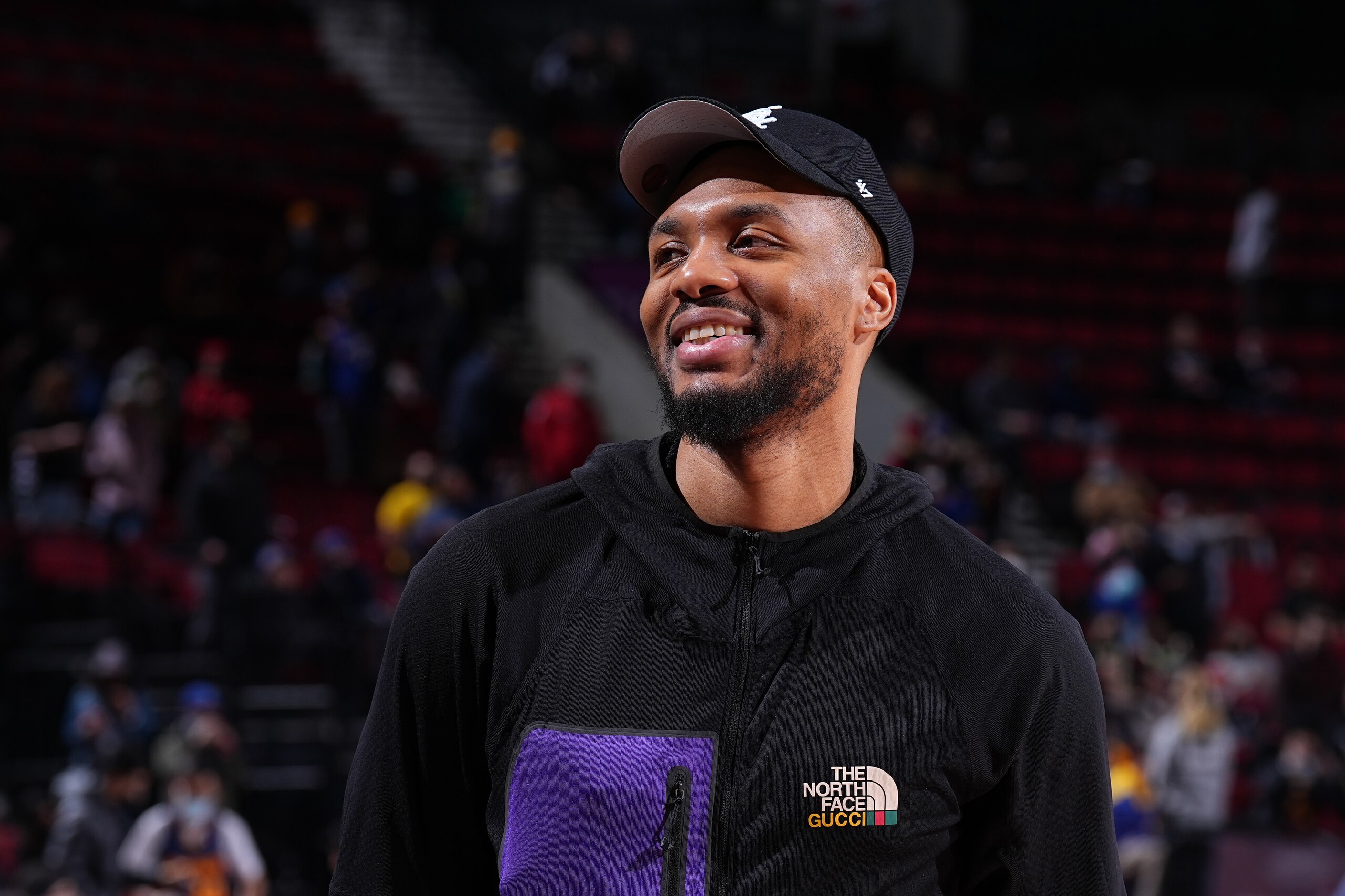 PORTLAND, OR - FEBRUARY 24: (EDITORS NOTE: this photo has been converted to black and white.) Damian Lillard #0 of the Portland Trail Blazers looks on and smiles before the game against the Golden State Warriors on February 24, 2022 at the Moda Center Arena in Portland, Oregon. NOTE TO USER: User expressly acknowledges and agrees that, by downloading and or using this photograph, user is consenting to the terms and conditions of the Getty Images License Agreement. Mandatory Copyright Notice: Copyright 2022 NBAE (Photo by Garrett Ellwood/NBAE via Getty Images)