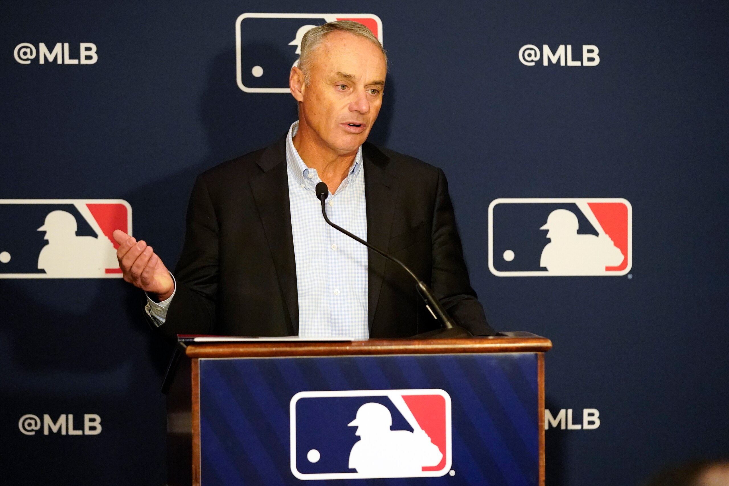 Major League Baseball commissioner Rob Manfred makes comments during a news conference at MLB baseball owners meetings, Thursday, Feb. 10, 2022, in Orlando, Fla. Manfred says spring training remains on hold because of a management lockout and his goal is to reach a labor contract that allows opening day as scheduled on March 31. (AP Photo/John Raoux)