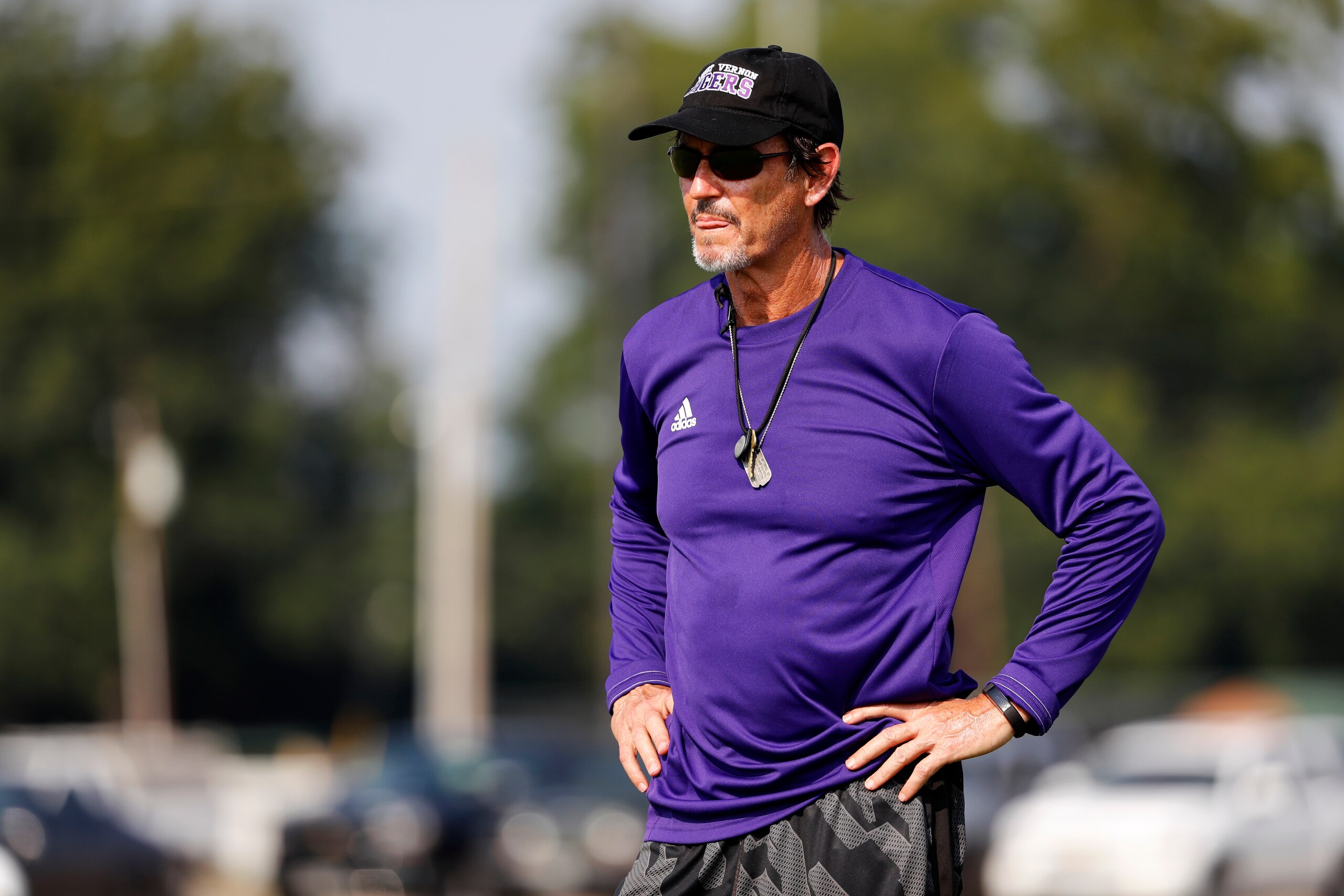 Coach Art Briles watches his team practice at Mount Vernon High School, Monday, Aug. 5, 2019, in Mount Vernon, Texas. Briles was back at his roots Monday, coaching a high school football team in Texas after a season in Italy and more than three years after the two-time Big 12 champion coach was fired by Baylor in the wake of a sexual assault scandal. (AP Photo/Tony Gutierrez)