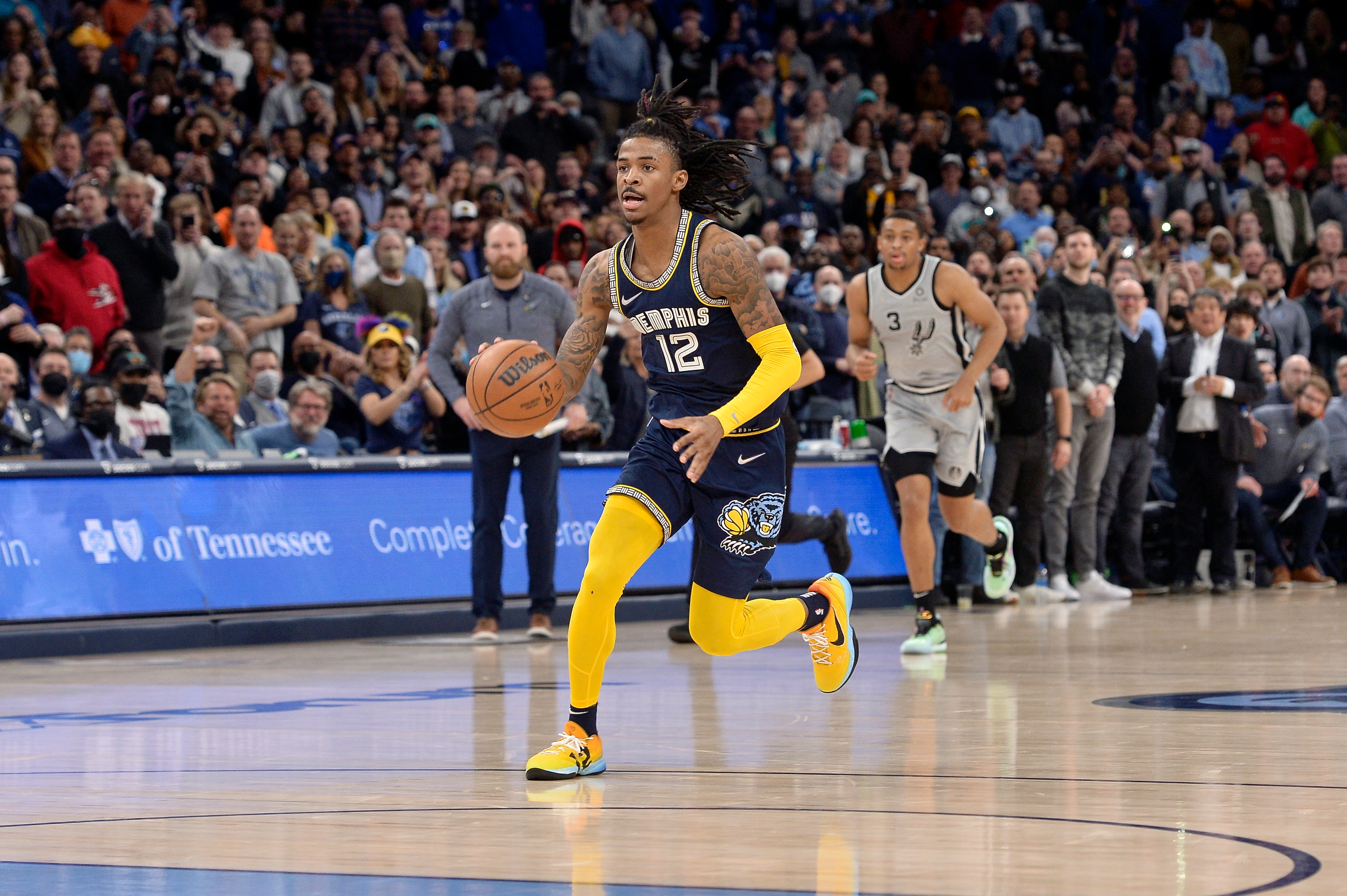 Memphis Grizzlies guard Ja Morant (12) handles the ball in the second half of an NBA basketball game against the San Antonio Spurs Monday, Feb. 28, 2022, in Memphis, Tenn. (AP Photo/Brandon Dill)