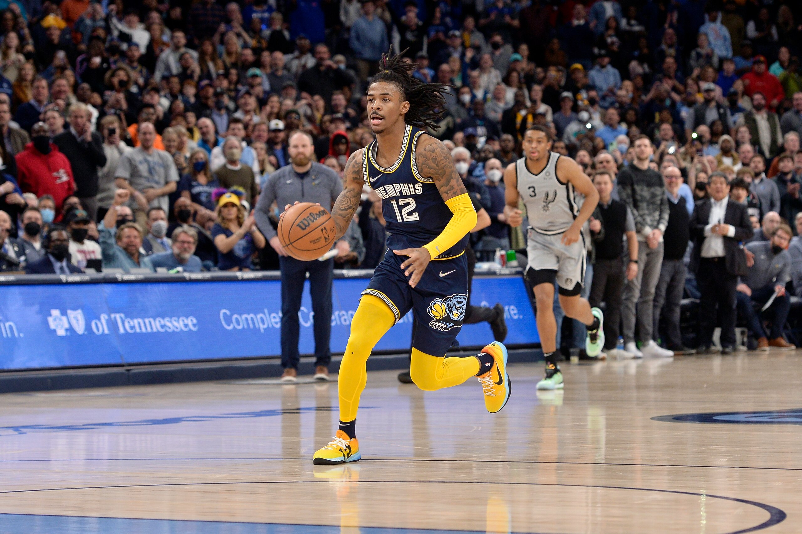Memphis Grizzlies guard Ja Morant (12) handles the ball in the second half of an NBA basketball game against the San Antonio Spurs Monday, Feb. 28, 2022, in Memphis, Tenn. (AP Photo/Brandon Dill)