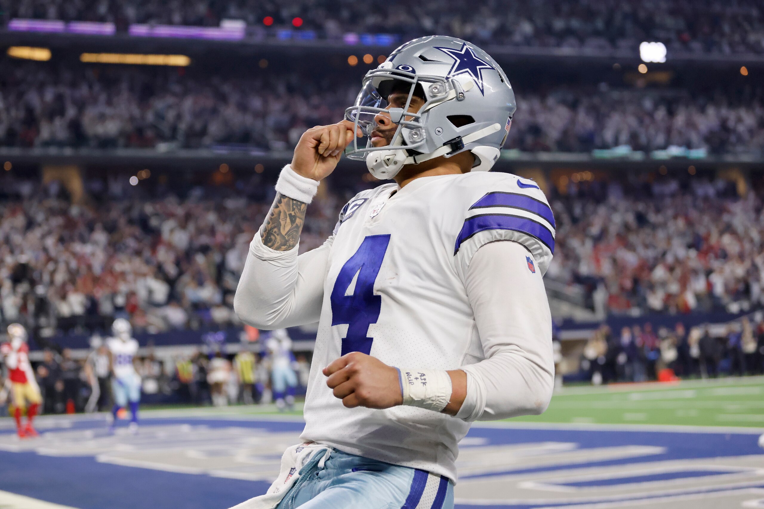 Dallas Cowboys quarterback Dak Prescott (4) celebrates running the ball for a touchdown in the second half of an NFL wild-card playoff football game against the San Franciso 49ers in Arlington, Texas, Sunday, Jan. 16, 2022. (AP Photo/Ron Jenkins)