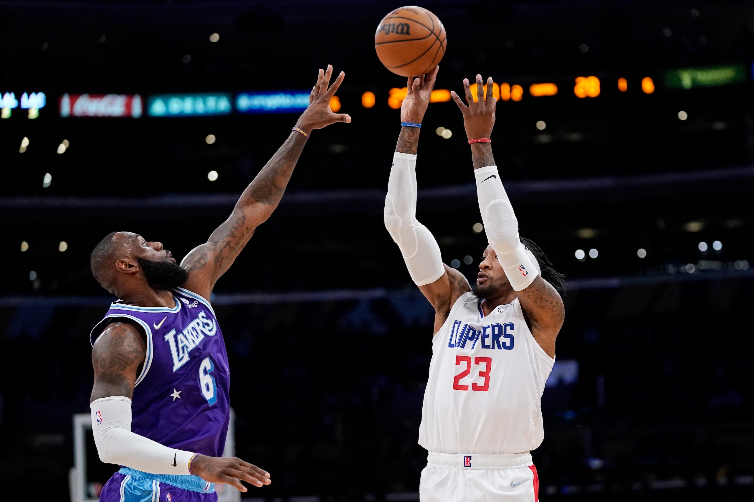 Los Angeles Clippers forward Robert Covington, right, shoots as Los Angeles Lakers forward LeBron James defends during the first half of an NBA basketball game Friday, Feb. 25, 2022, in Los Angeles. (AP Photo/Mark J. Terrill) Los Angeles Clippers forward Robert Covington, right, shoots as Los Angeles Lakers forward LeBron James defends during the first half of an NBA basketball game Friday, Feb. 25, 2022, in Los Angeles. (AP Photo/Mark J. Terrill)