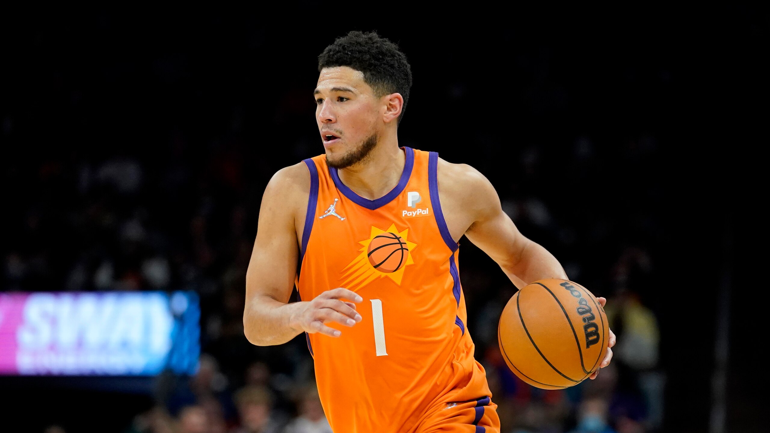 Phoenix Suns guard Devin Booker (1) drives against the New Orleans Pelicans during the second half of an NBA basketball game, Friday, Feb. 25, 2022, in Phoenix. (AP Photo/Matt York)