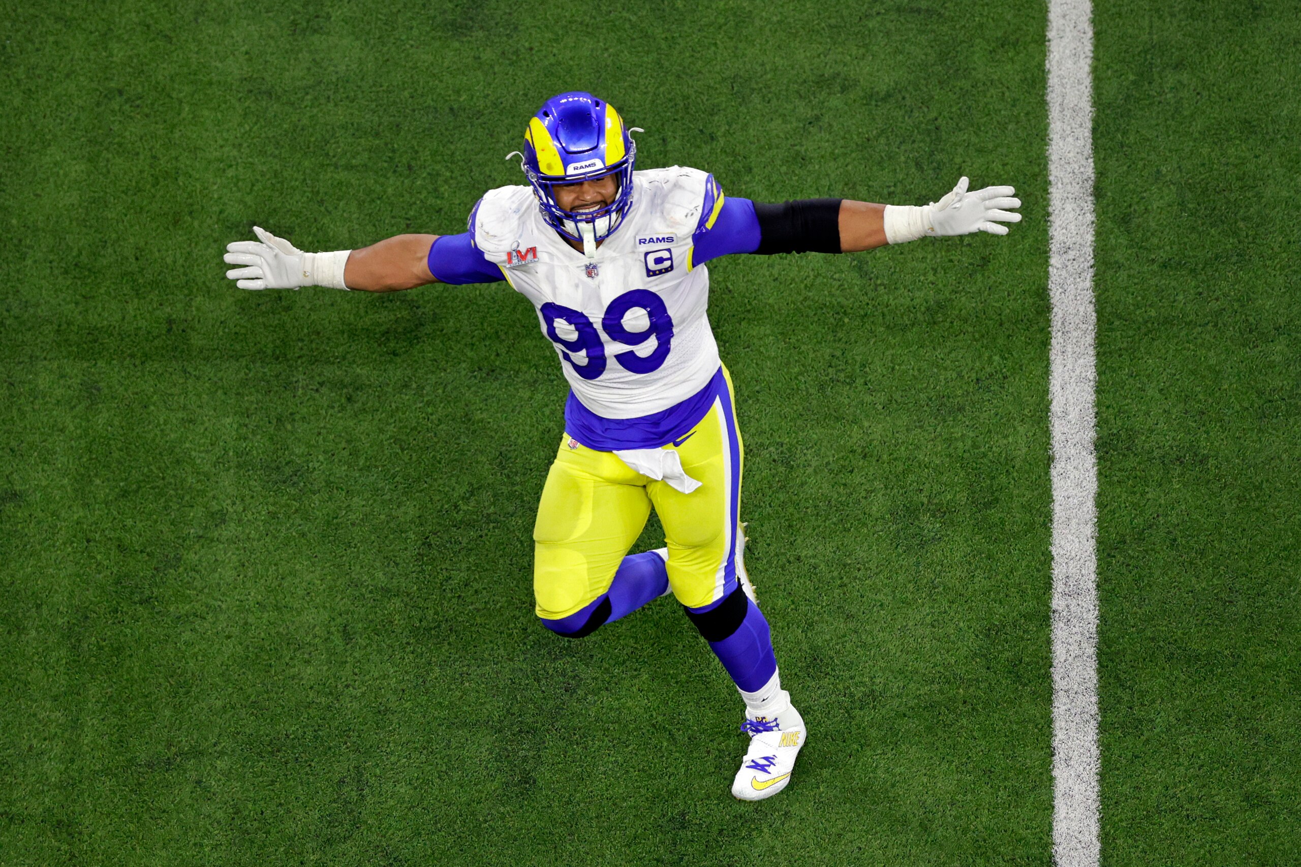 Los Angeles Rams defensive end Aaron Donald (99) reacts after sacking Cincinnati Bengals quarterback Joe Burrow (9) during the NFL Super Bowl 56 football game Sunday, Feb. 13, 2022, in Inglewood, Calif. (AP Photo/Adam Hunger)