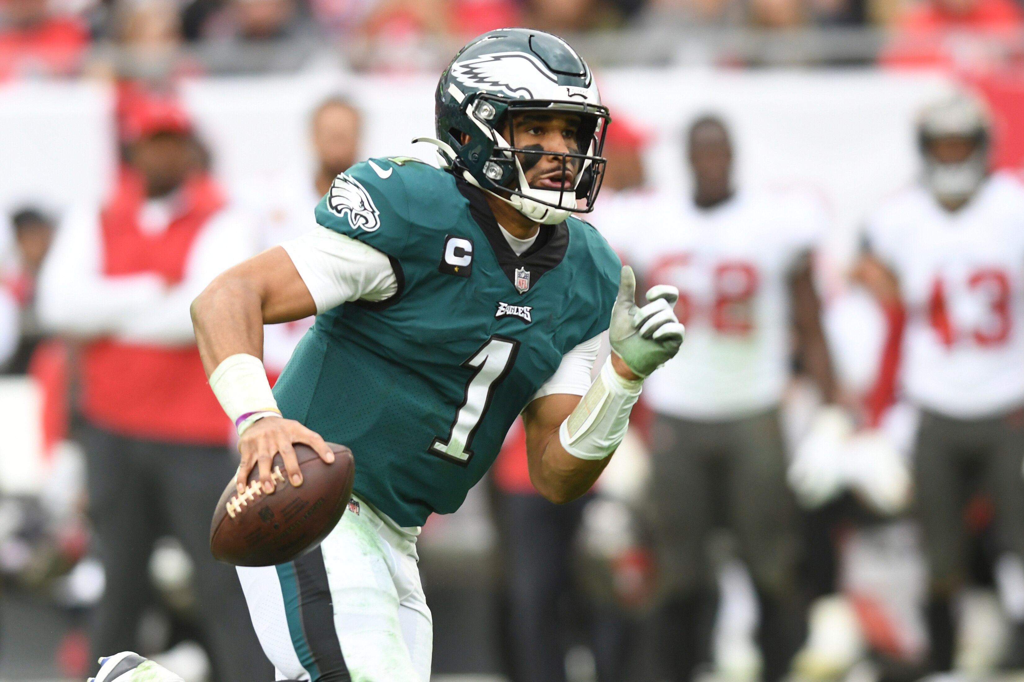 Philadelphia Eagles quarterback Jalen Hurts (1) runs against the Tampa Bay Buccaneers during the second half of an NFL wild-card football game Sunday, Jan. 16, 2022, in Tampa, Fla. (AP Photo/Jason Behnken)