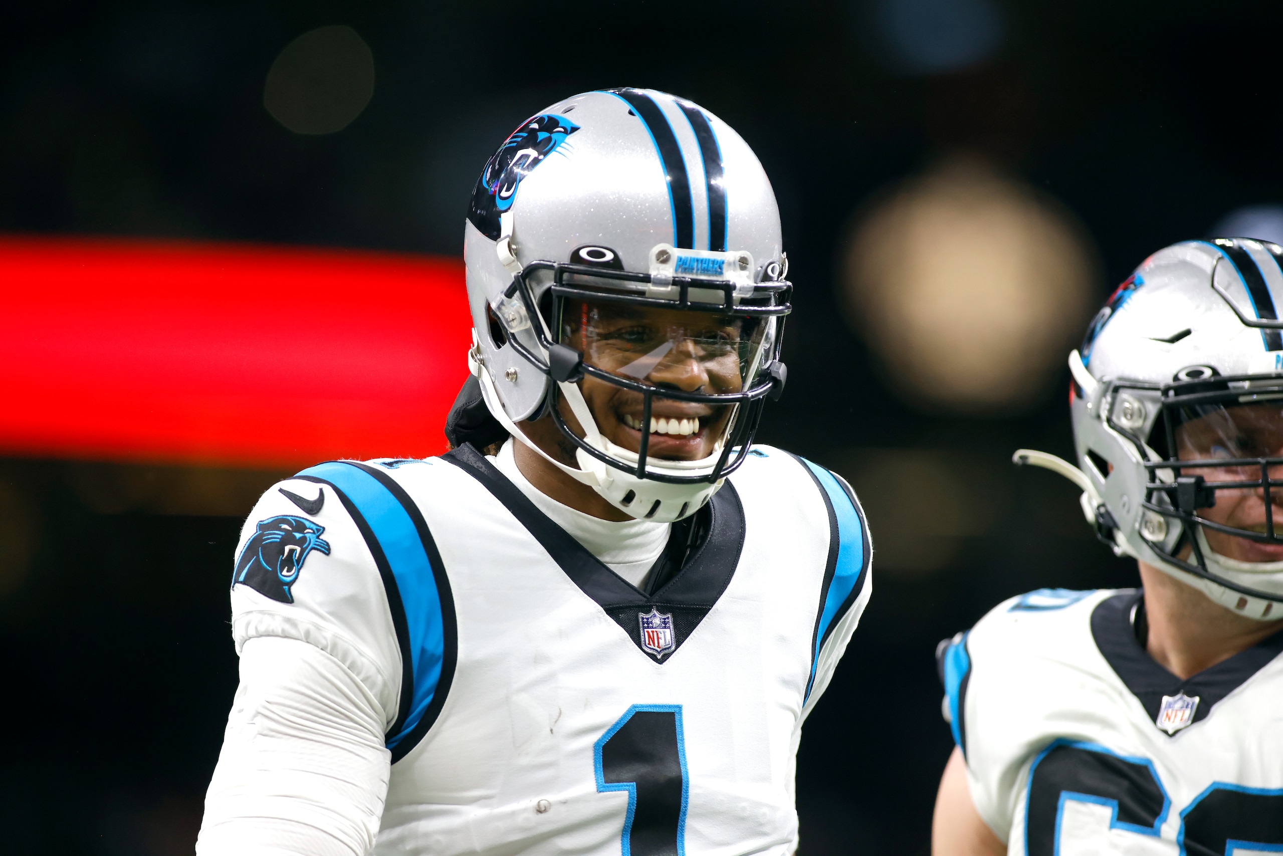 Carolina Panthers quarterback Cam Newton (1) celebrates with guard Pat Elflein (60) after their team scores a touchdown during an NFL football game against the New Orleans Saints, Sunday, Jan. 2, 2022, in New Orleans. (AP Photo/Tyler Kaufman)