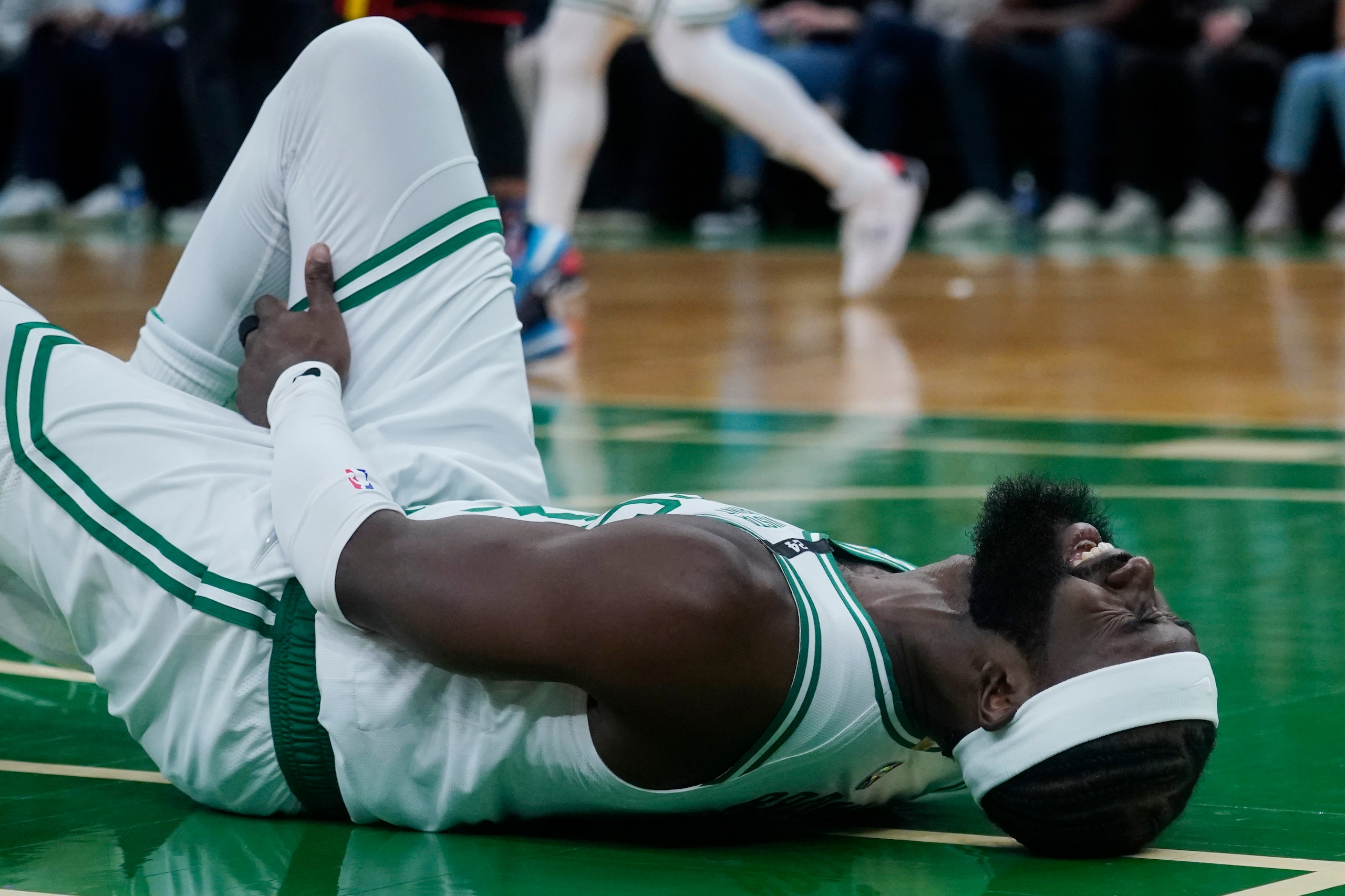 Boston Celtics guard Jaylen Brown (7) reacts after an apparent injury during an NBA basketball game, Wednesday, March 2, 2022 in Boston. (AP Photo/Charles Krupa)
