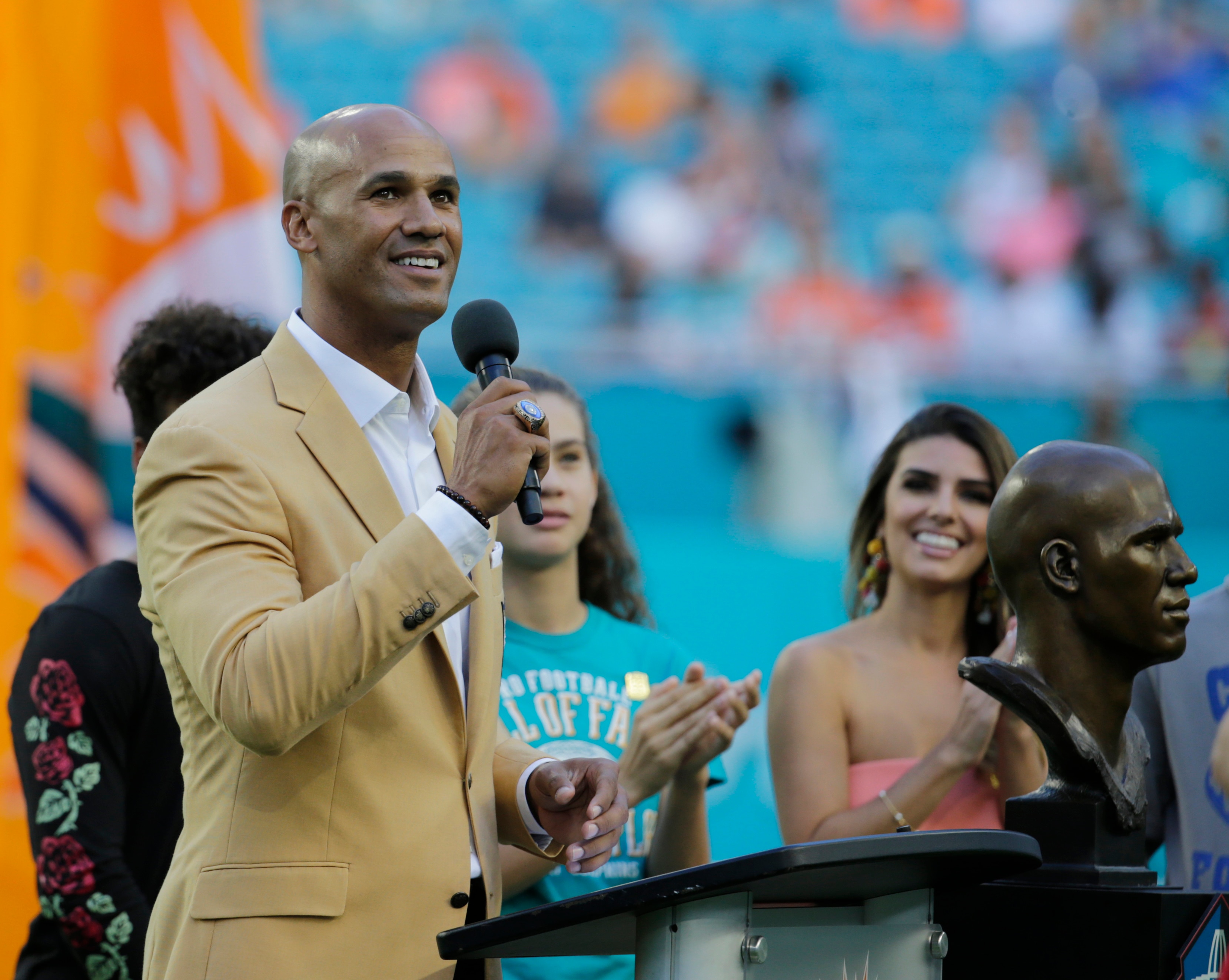Former Miami Dolphins player Jason Taylor acknowledges the cheers from the crowd during a ceremony celebrating his induction into the Football Hall of Fame during the half time show at an NFL football game against the Denver Broncos, Sunday, Dec. 3, 2017, in Miami Gardens, Fla. (AP Photo/Lynne Sladky)